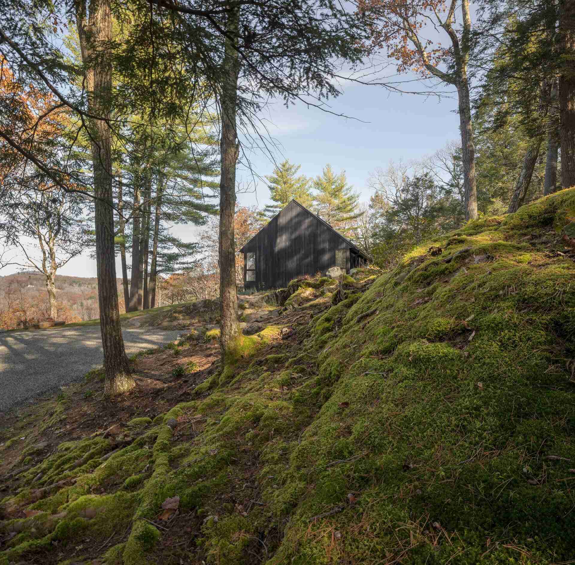 A modern home in Cornwall, Connecticut, built directly on a dramatic rock ledge. Inspired by local barns and the historic West Cornwall Covered Bridge, this forest retreat blends charred wood siding with contemporary design.