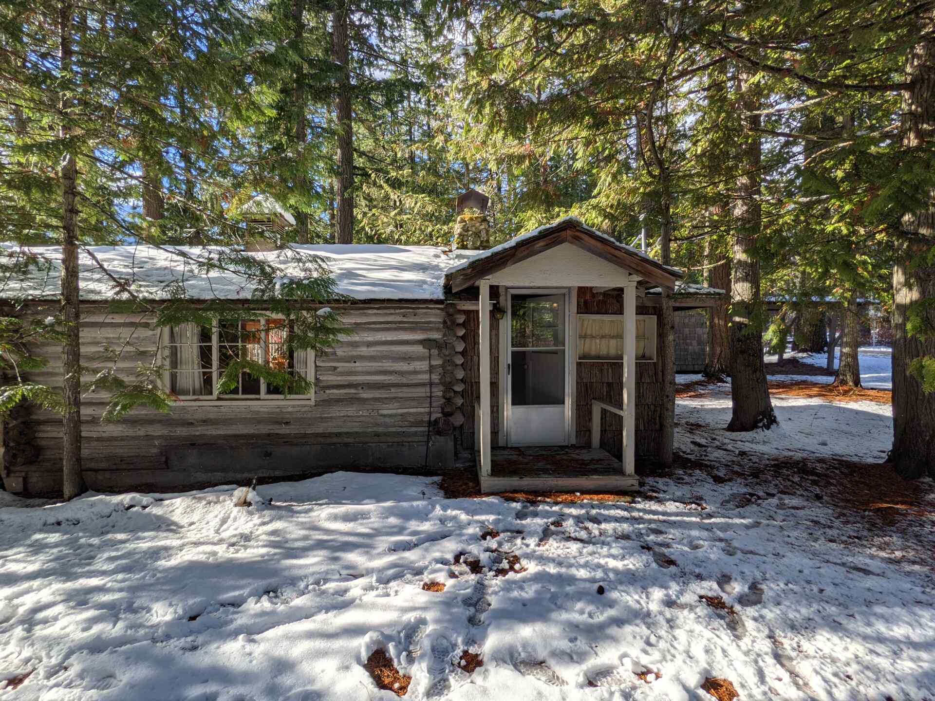 BEFORE - A modern lake house on Lake Wenatchee is built entirely around a preserved 1915 log cabin, turning history into the home’s centerpiece.