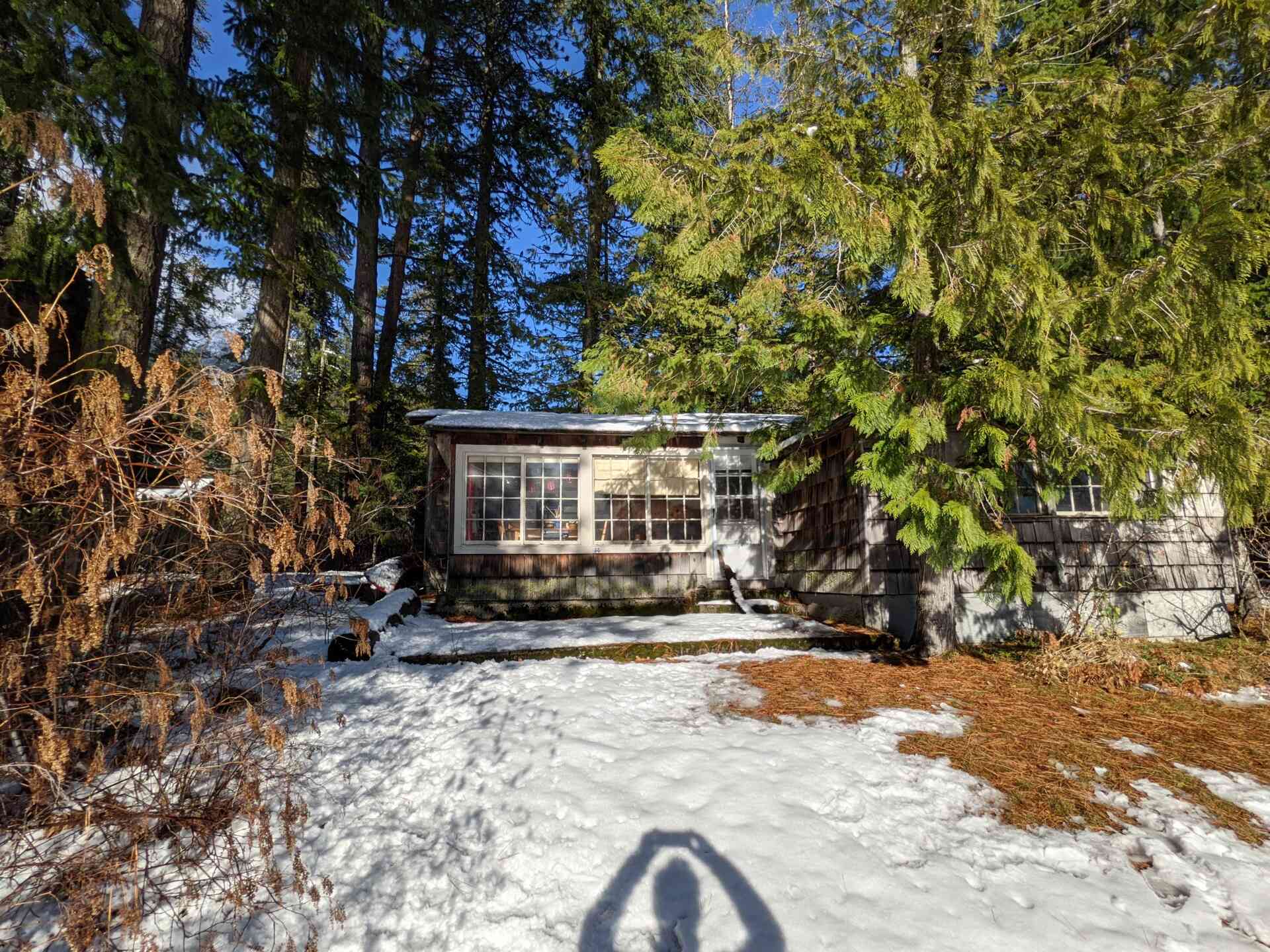 BEFORE - A modern lake house on Lake Wenatchee is built entirely around a preserved 1915 log cabin, turning history into the home’s centerpiece.