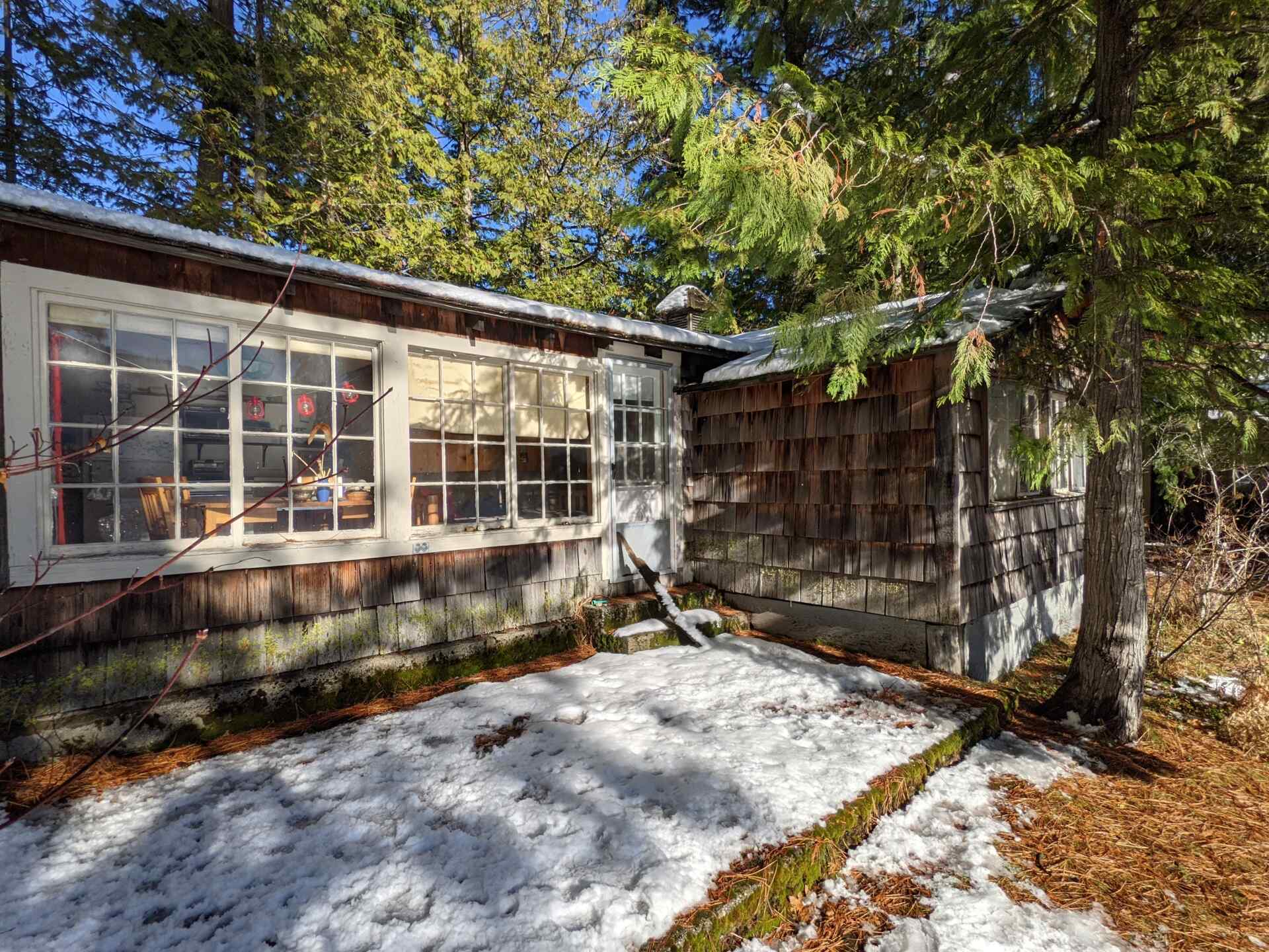 BEFORE - A modern lake house on Lake Wenatchee is built entirely around a preserved 1915 log cabin, turning history into the home’s centerpiece.