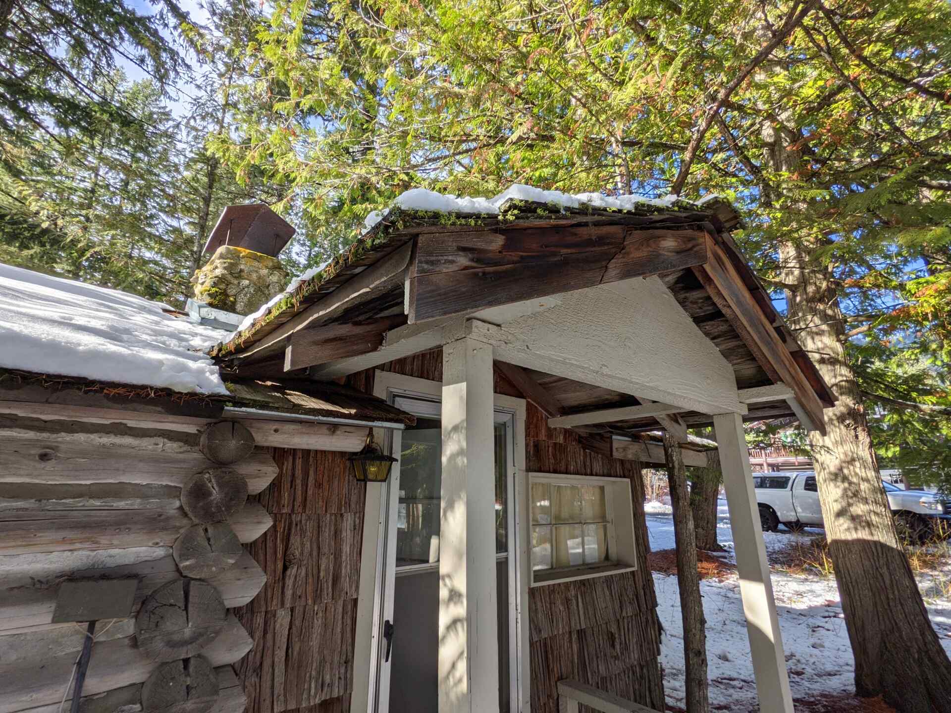 BEFORE - A modern lake house on Lake Wenatchee is built entirely around a preserved 1915 log cabin, turning history into the home’s centerpiece.