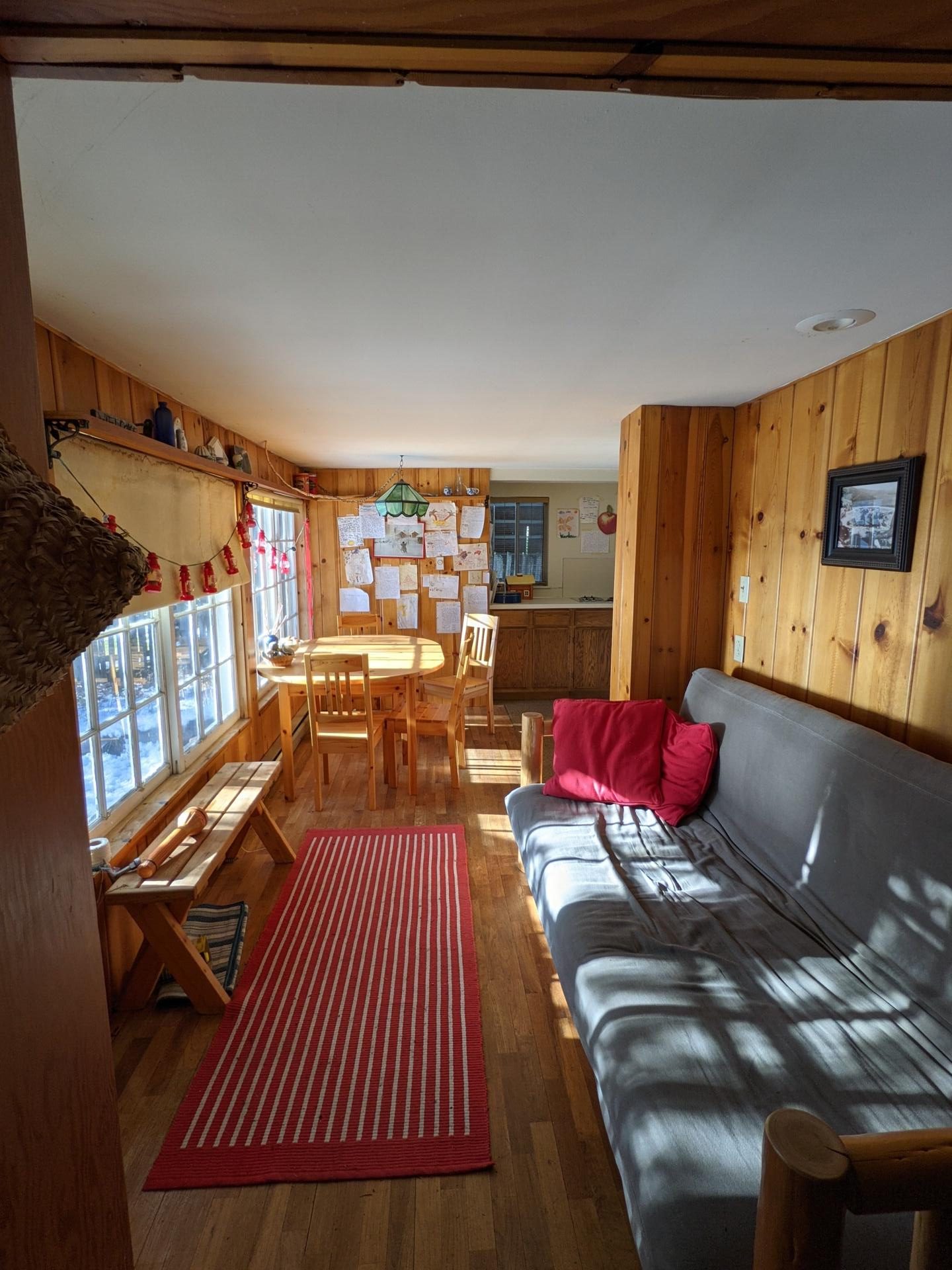 BEFORE - A modern lake house on Lake Wenatchee is built entirely around a preserved 1915 log cabin, turning history into the home’s centerpiece.