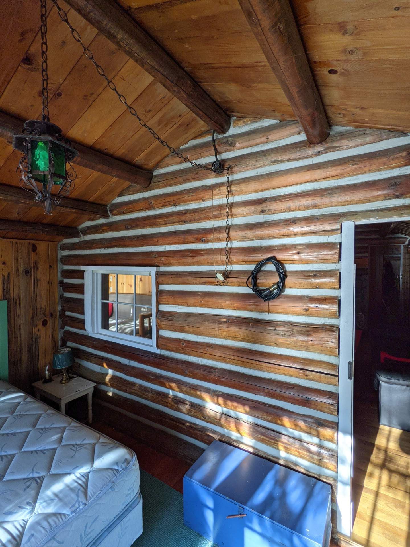 BEFORE - A modern lake house on Lake Wenatchee is built entirely around a preserved 1915 log cabin, turning history into the home’s centerpiece.