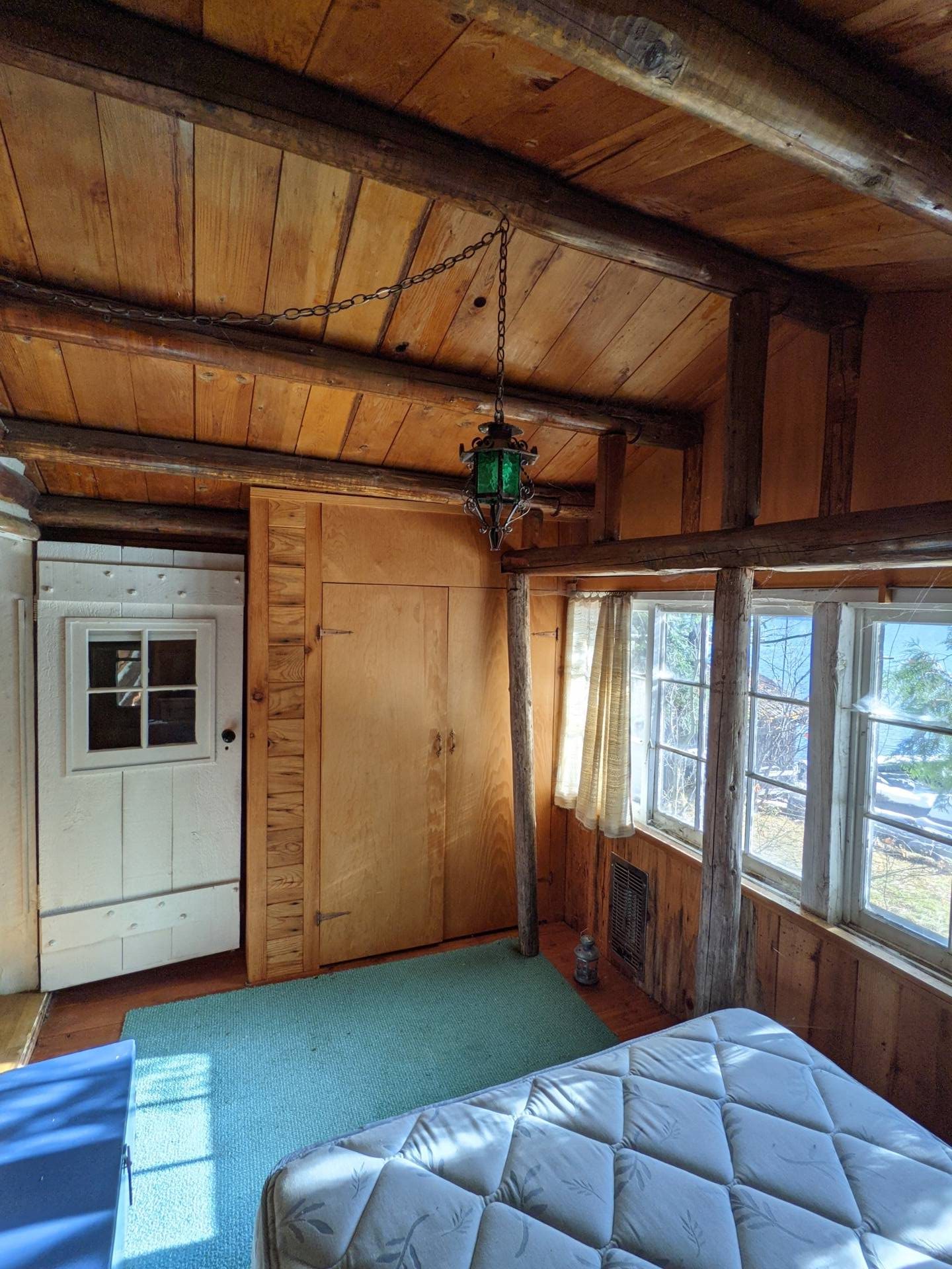 BEFORE - A modern lake house on Lake Wenatchee is built entirely around a preserved 1915 log cabin, turning history into the home’s centerpiece.
