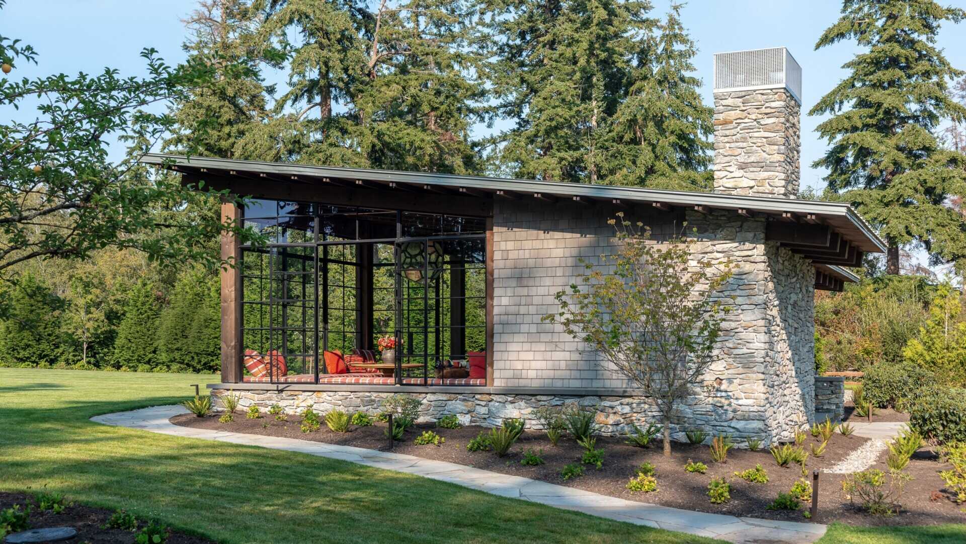 Inspired by Civilian Conservation Corps park structures, this Pacific Northwest pavilion blends rugged stone, timber and a simple shed roof form for a timeless look rooted in nature.