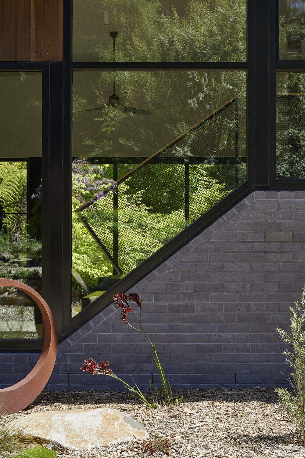 A sustainable split-level home in Melbourne designed for bushland living, featuring Ironbark cladding and innovative Timbercrete blockwork that blends strength with warmth.