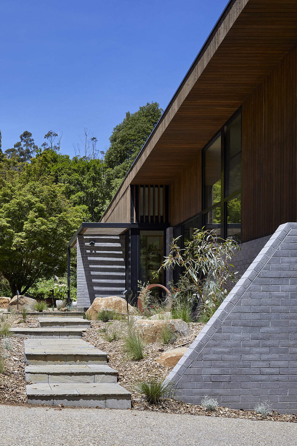 A sustainable split-level home in Melbourne designed for bushland living, featuring Ironbark cladding and innovative Timbercrete blockwork that blends strength with warmth.