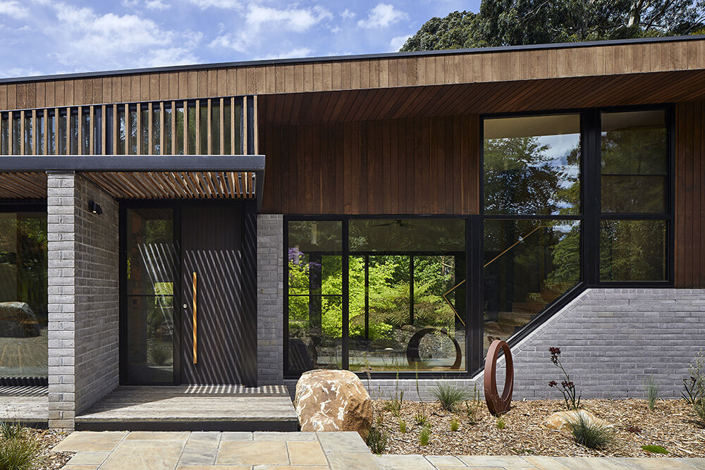 A sustainable split-level home in Melbourne designed for bushland living, featuring Ironbark cladding and innovative Timbercrete blockwork that blends strength with warmth.