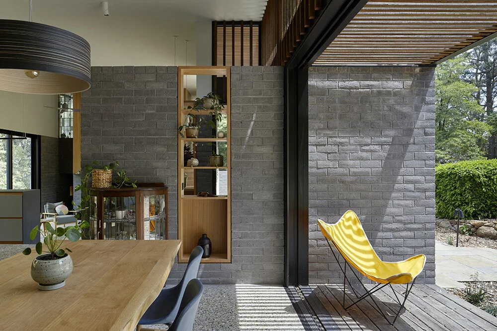 Timbercrete blockwork continues inside, paired with polished aggregate concrete floors and local hardwood for a warm yet durable interior.