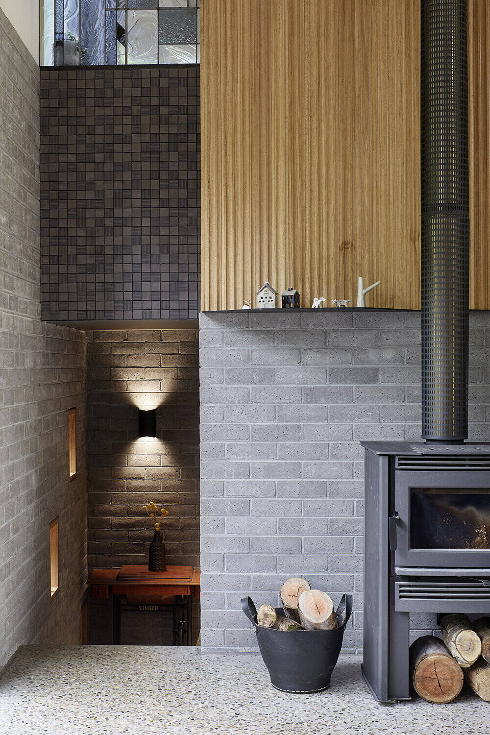 Timbercrete blockwork continues inside, paired with polished aggregate concrete floors and local hardwood for a warm yet durable interior.