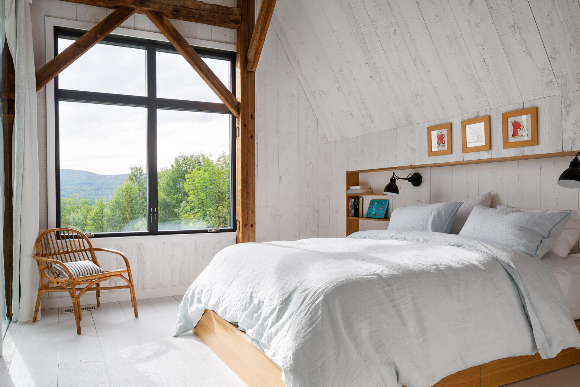 Barn bedrooms on the upper level feature treetop views and a calm, natural material palette.