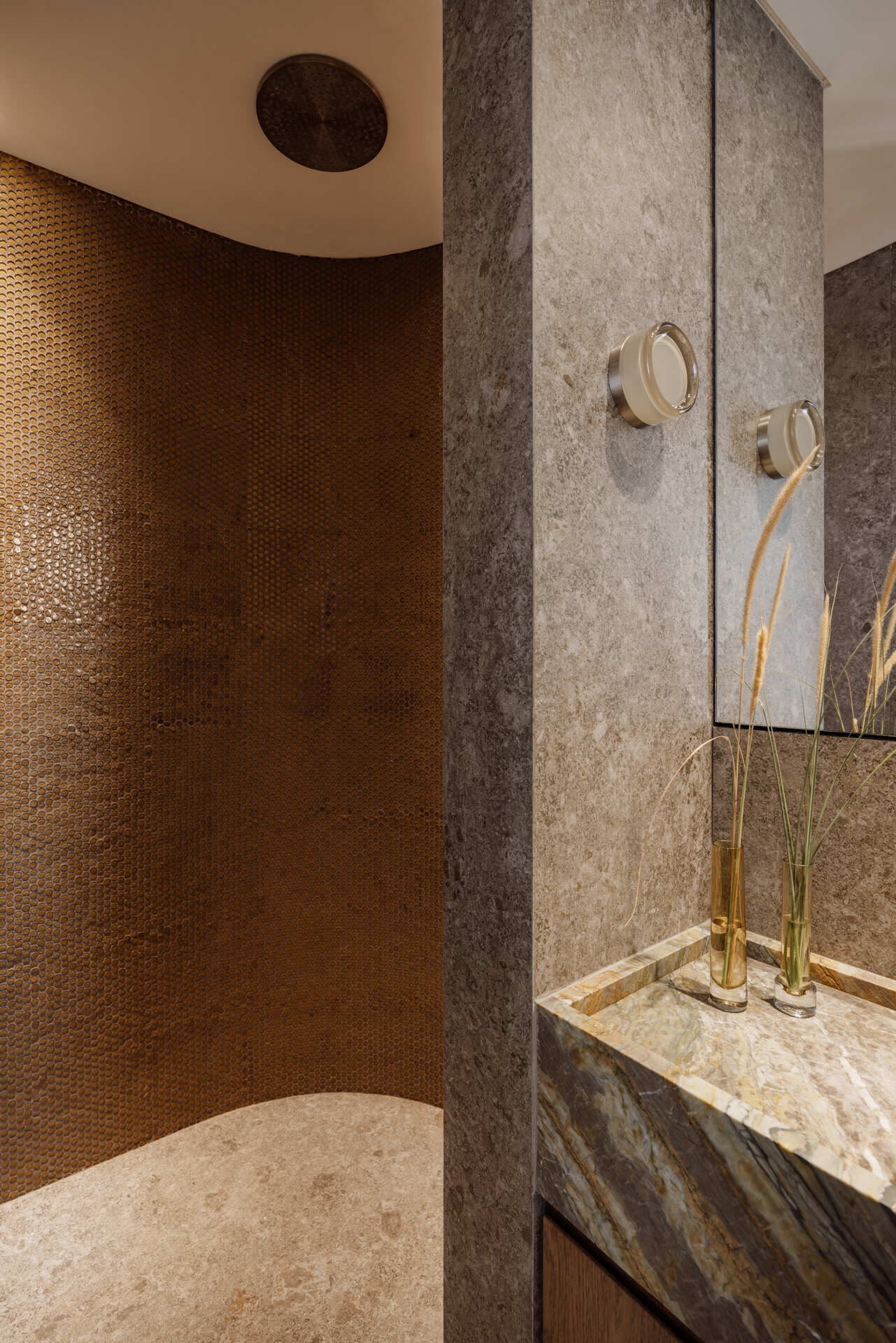 Tactile marble and ceramic bathrooms that continue a biophilic design approach focused on calm and connection to nature.