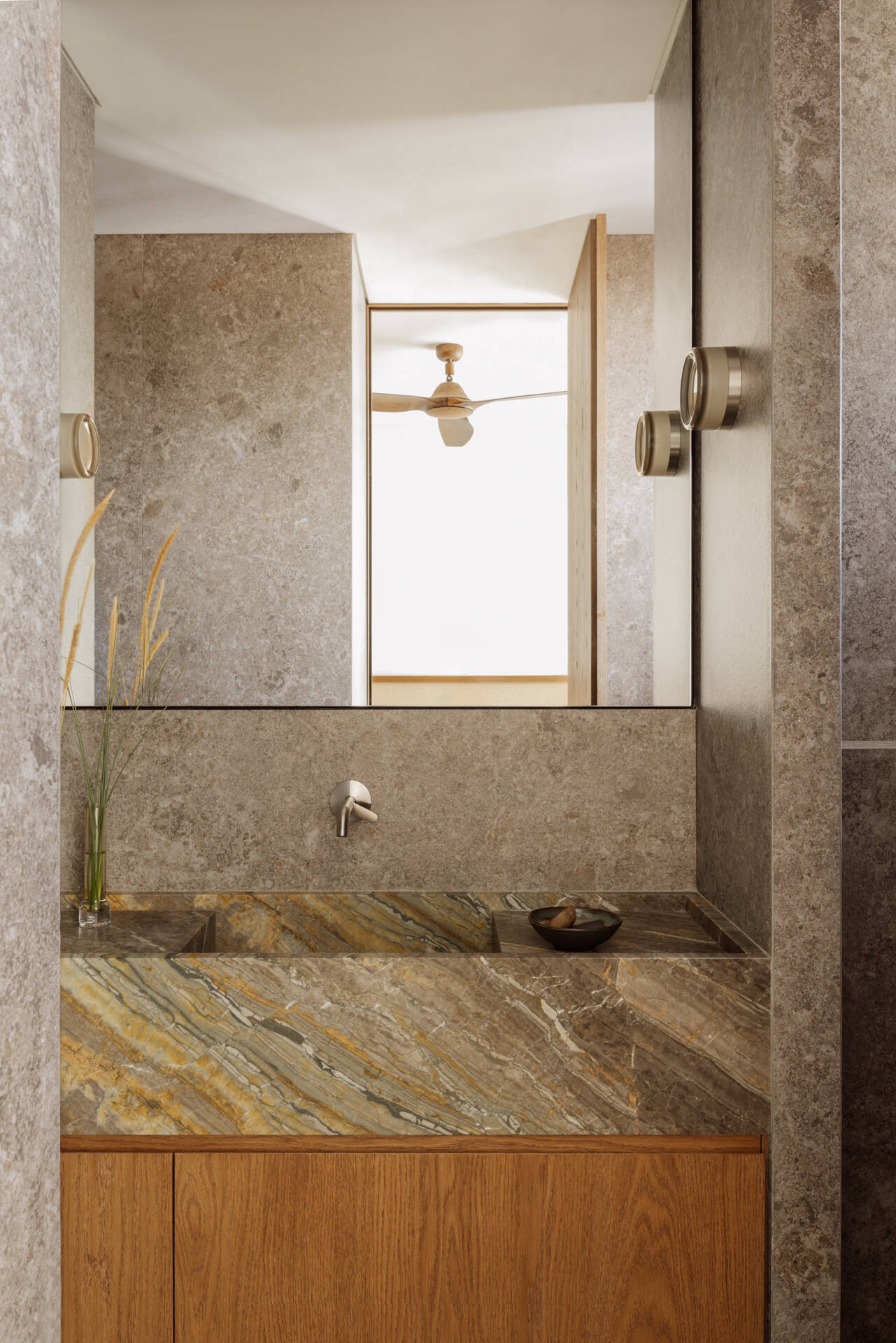 Tactile marble and ceramic bathrooms that continue a biophilic design approach focused on calm and connection to nature.