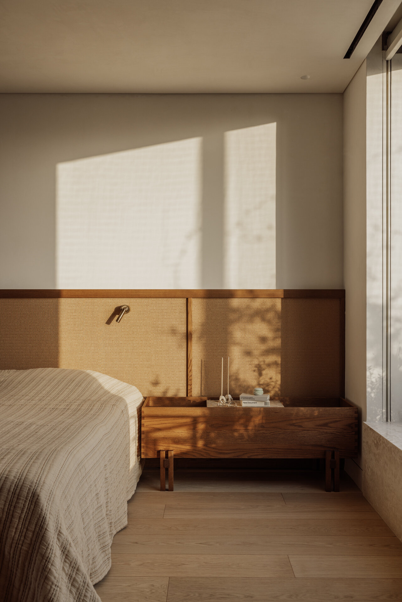 A modern bedroom has been finished with wood and earth tones.