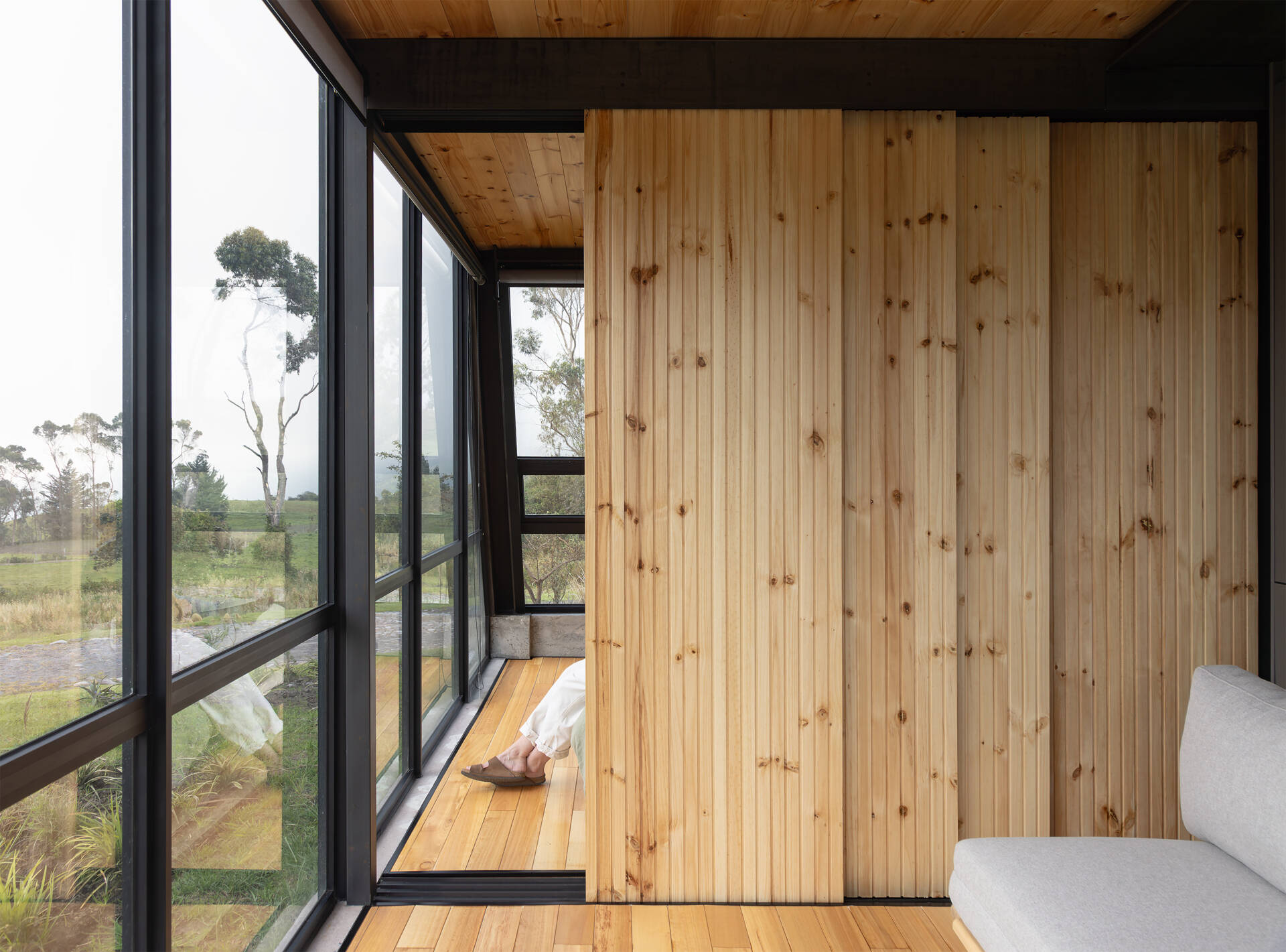 Private spaces sit on the upper floor, with a small viewing loft that opens north and south toward nearby volcanoes.