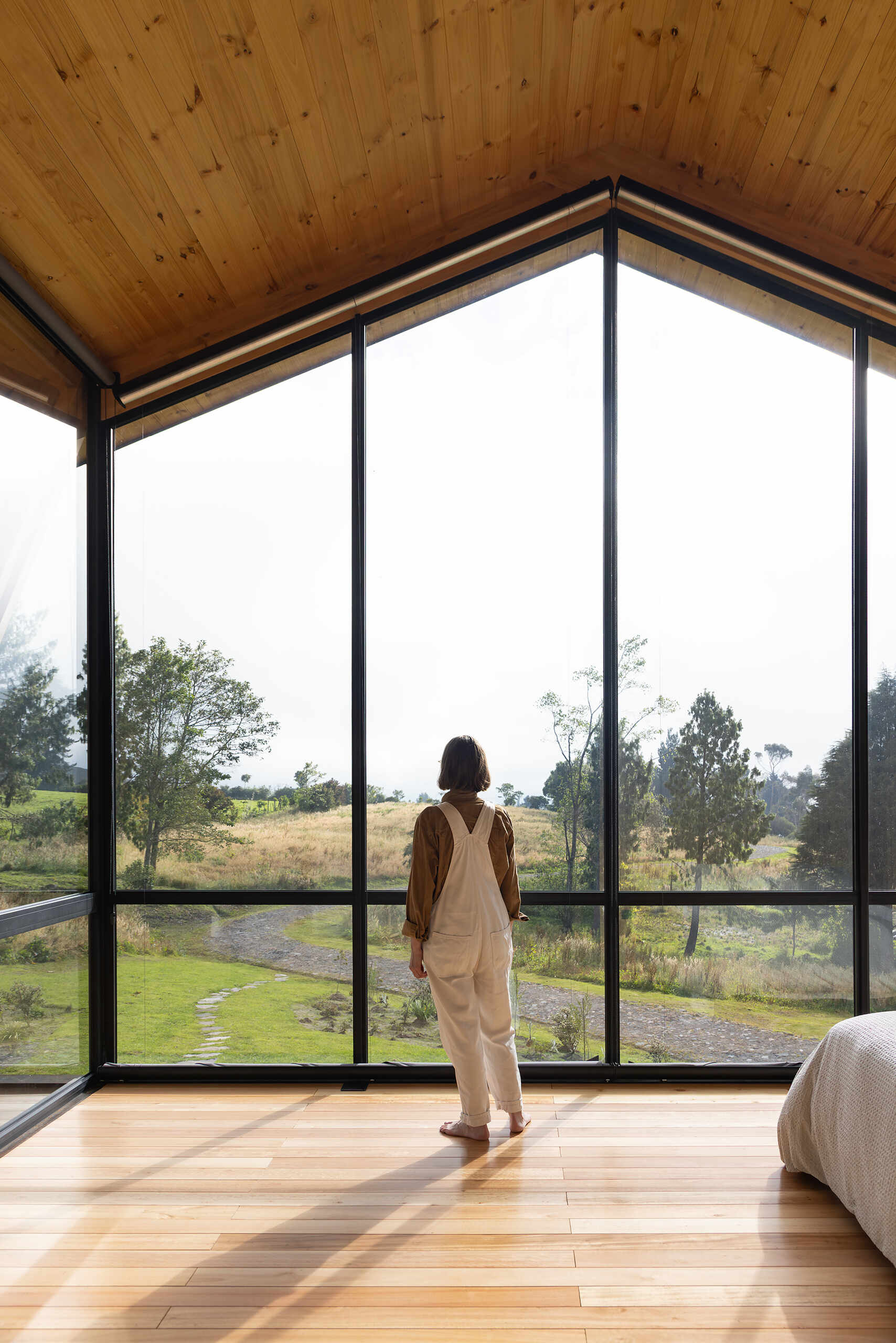 Private spaces sit on the upper floor, with a small viewing loft that opens north and south toward nearby volcanoes.