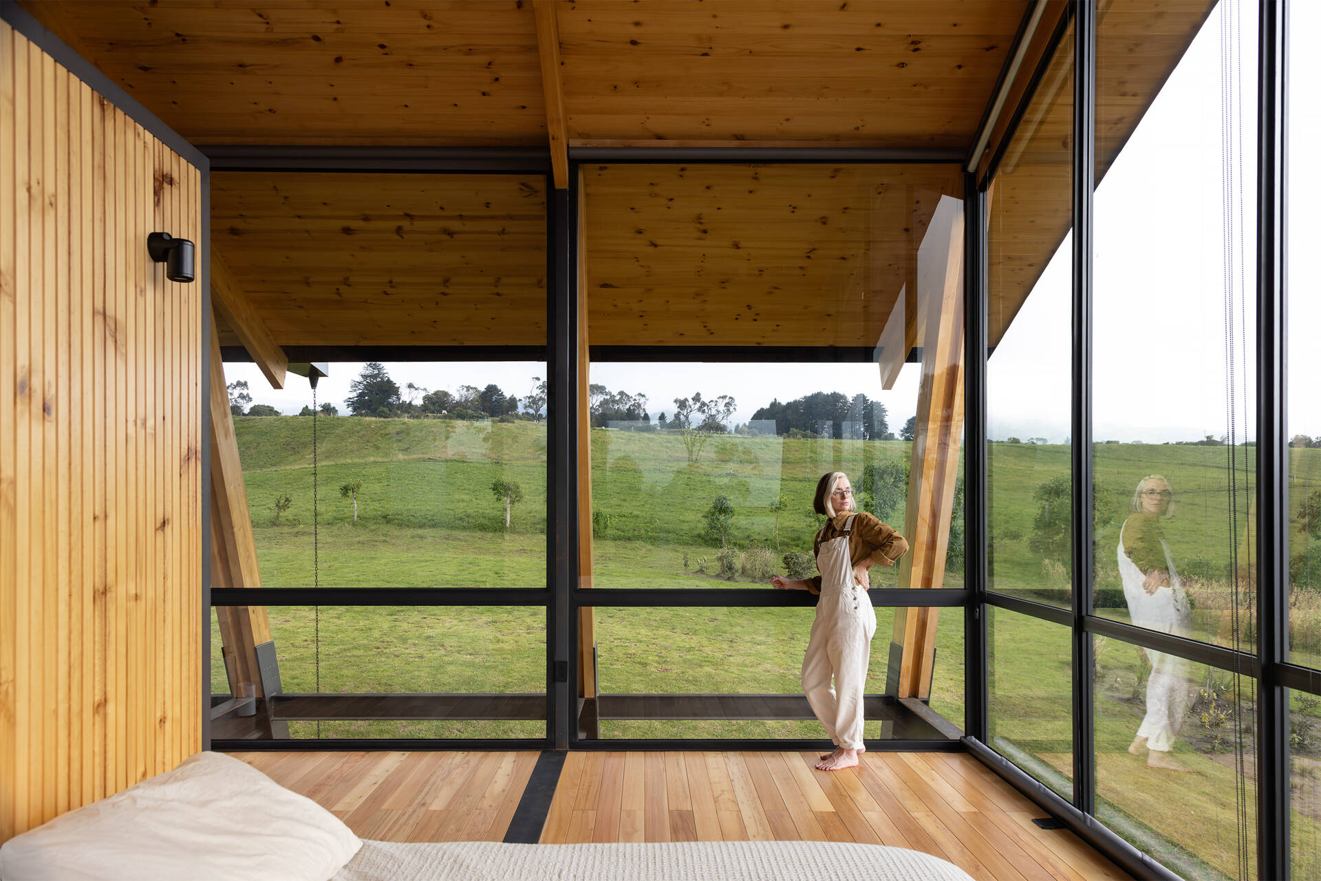 Private spaces sit on the upper floor, with a small viewing loft that opens north and south toward nearby volcanoes.