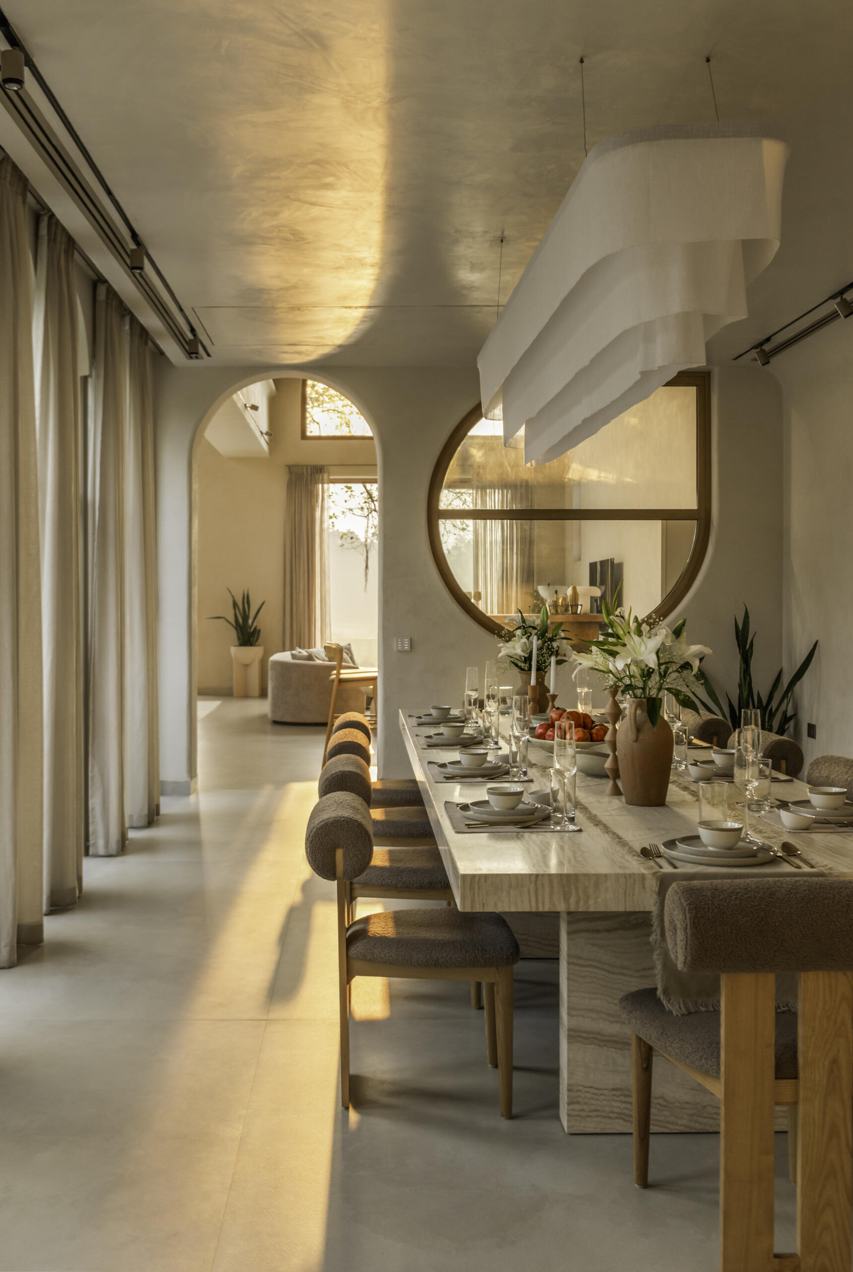 A twenty-seater dining table anchors the home, facing a central courtyard and connecting private bedrooms with shared living areas in this Goa hotel-home.
