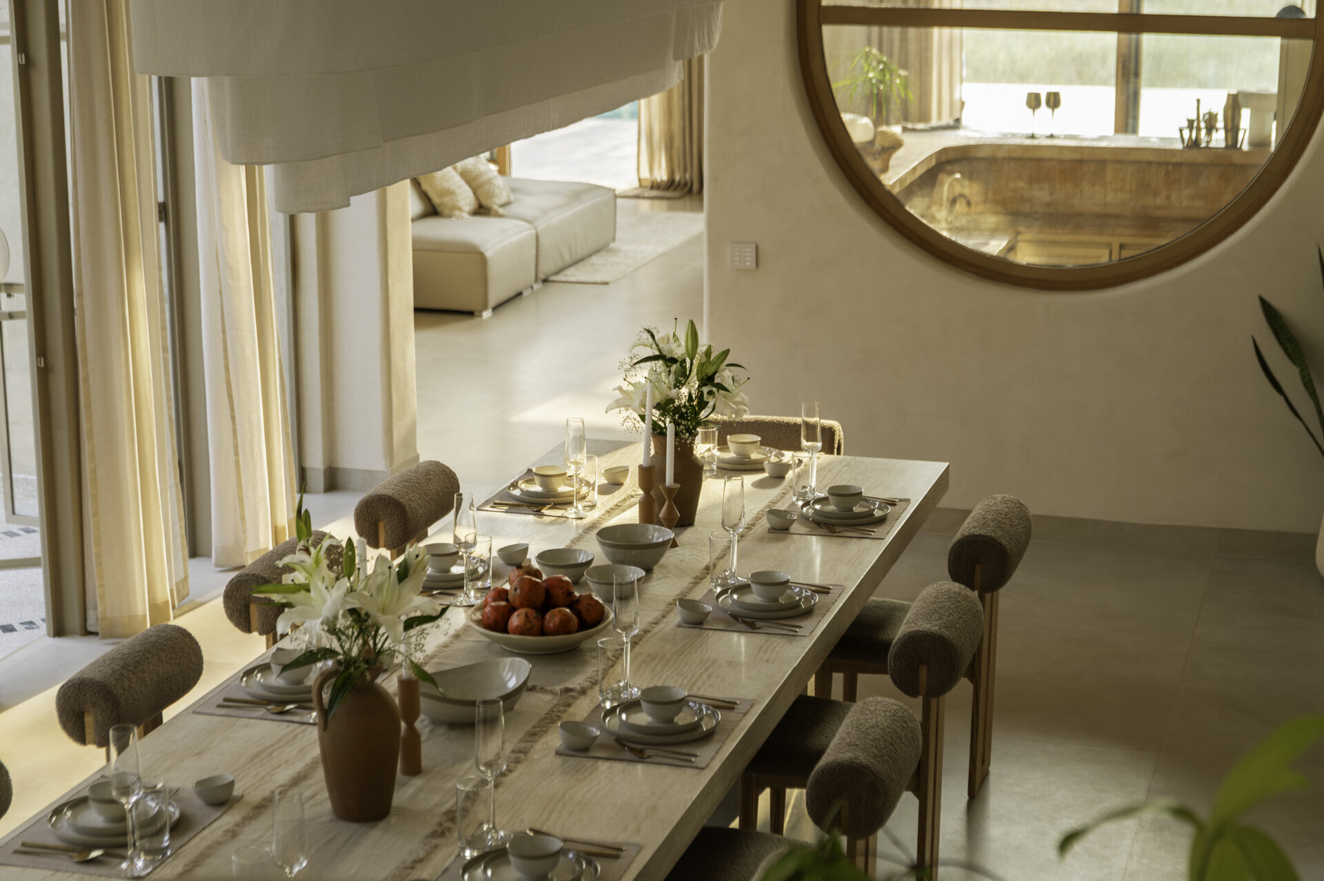 A twenty-seater dining table anchors the home, facing a central courtyard and connecting private bedrooms with shared living areas in this Goa hotel-home.