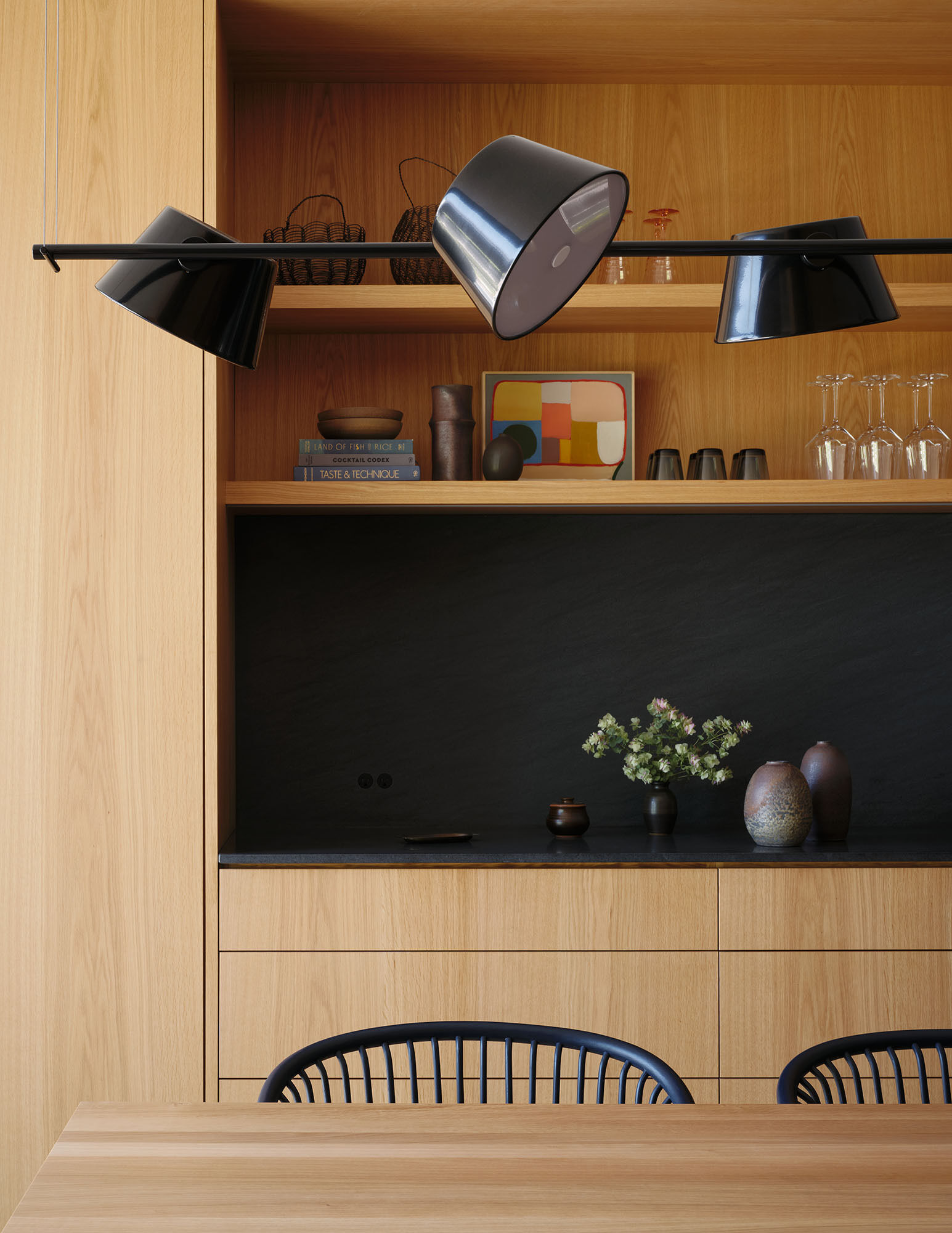An open kitchen and dining area becomes the social center of the home, designed for everyday family life and connection to the outdoors.
