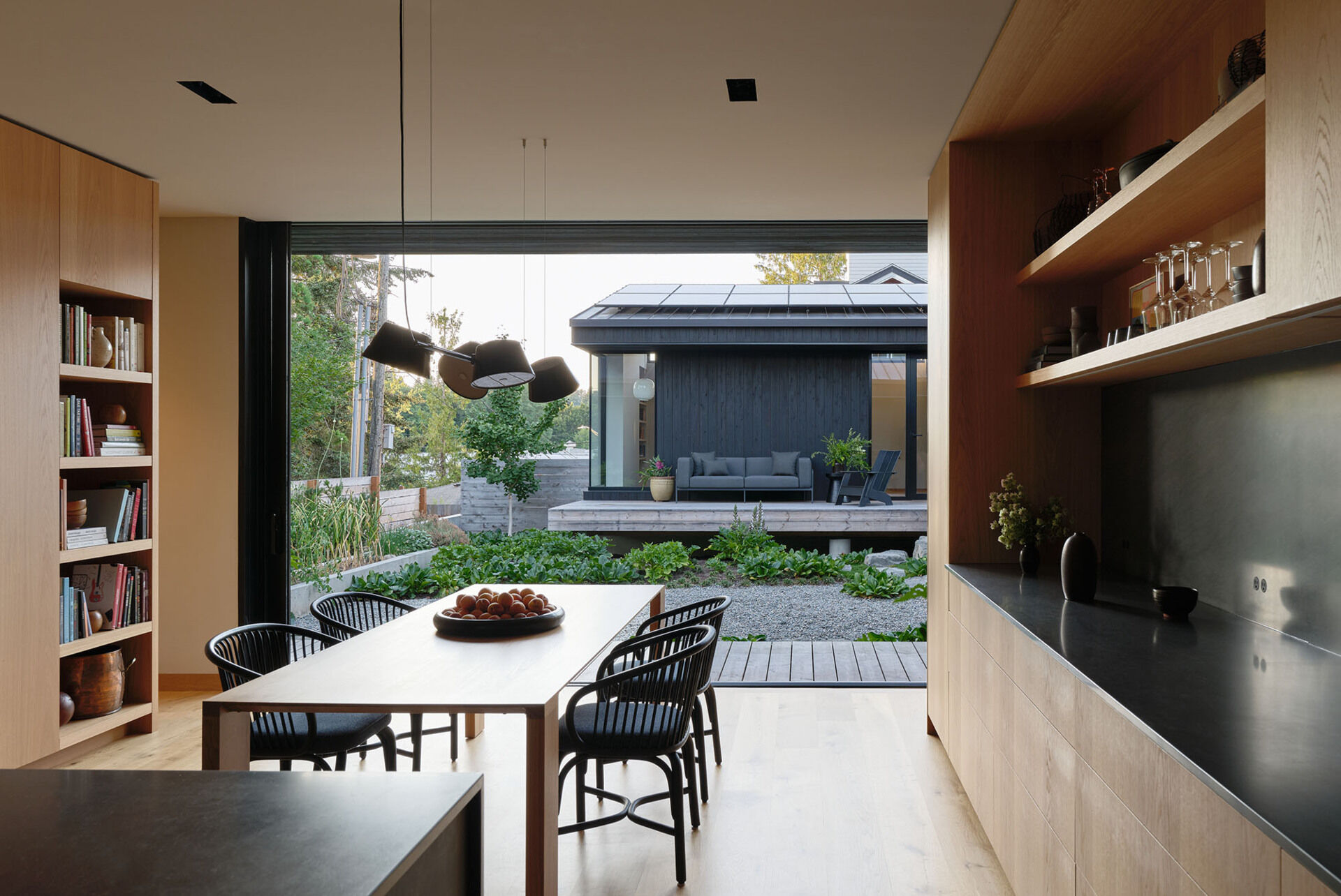 An open kitchen and dining area becomes the social center of the home, designed for everyday family life and connection to the outdoors.