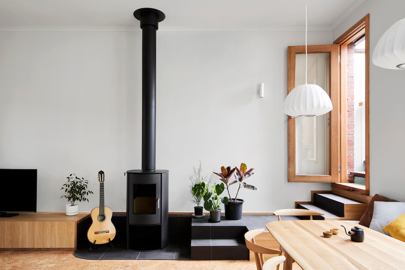 Built-in bench seating in the dining area leads directly to a sunlit rooftop deck.