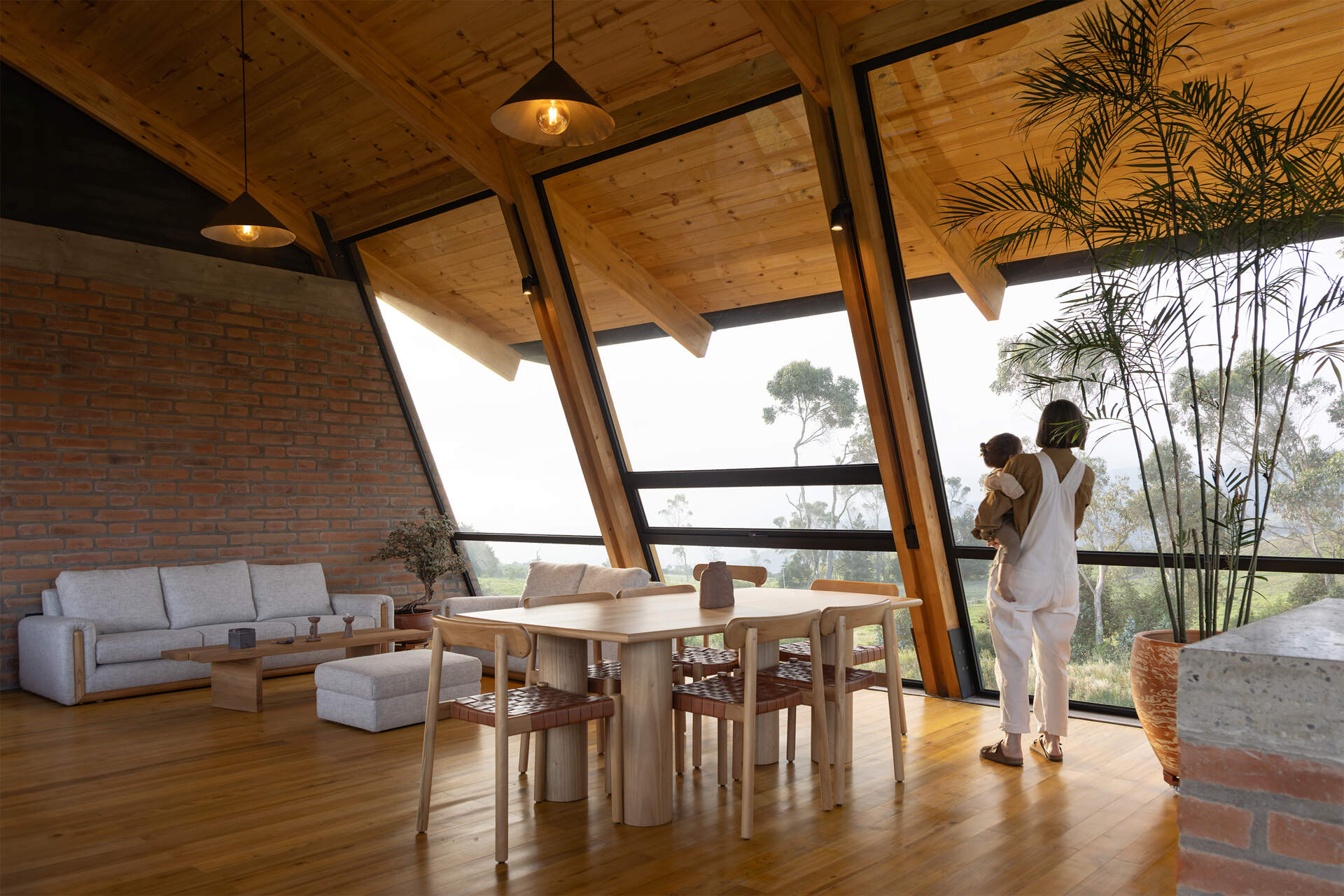 An elevated great room opens to meadows and volcanoes. Living, dining, and kitchen share one expansive level designed for daily life above the terrain.