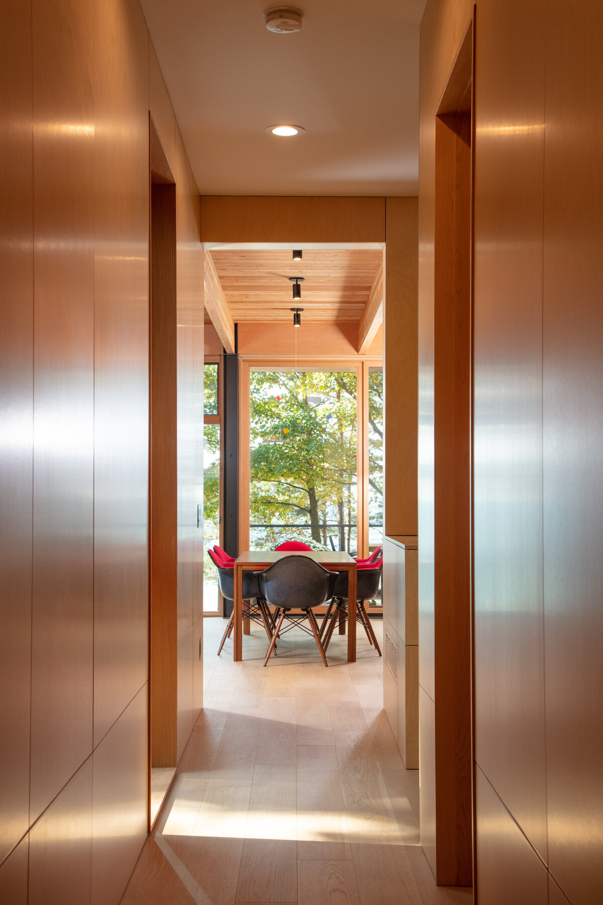 The wood-lined hallway at the top of the stairs connects the social areas of the home to the bedrooms and bathrooms located on both levels of the home.