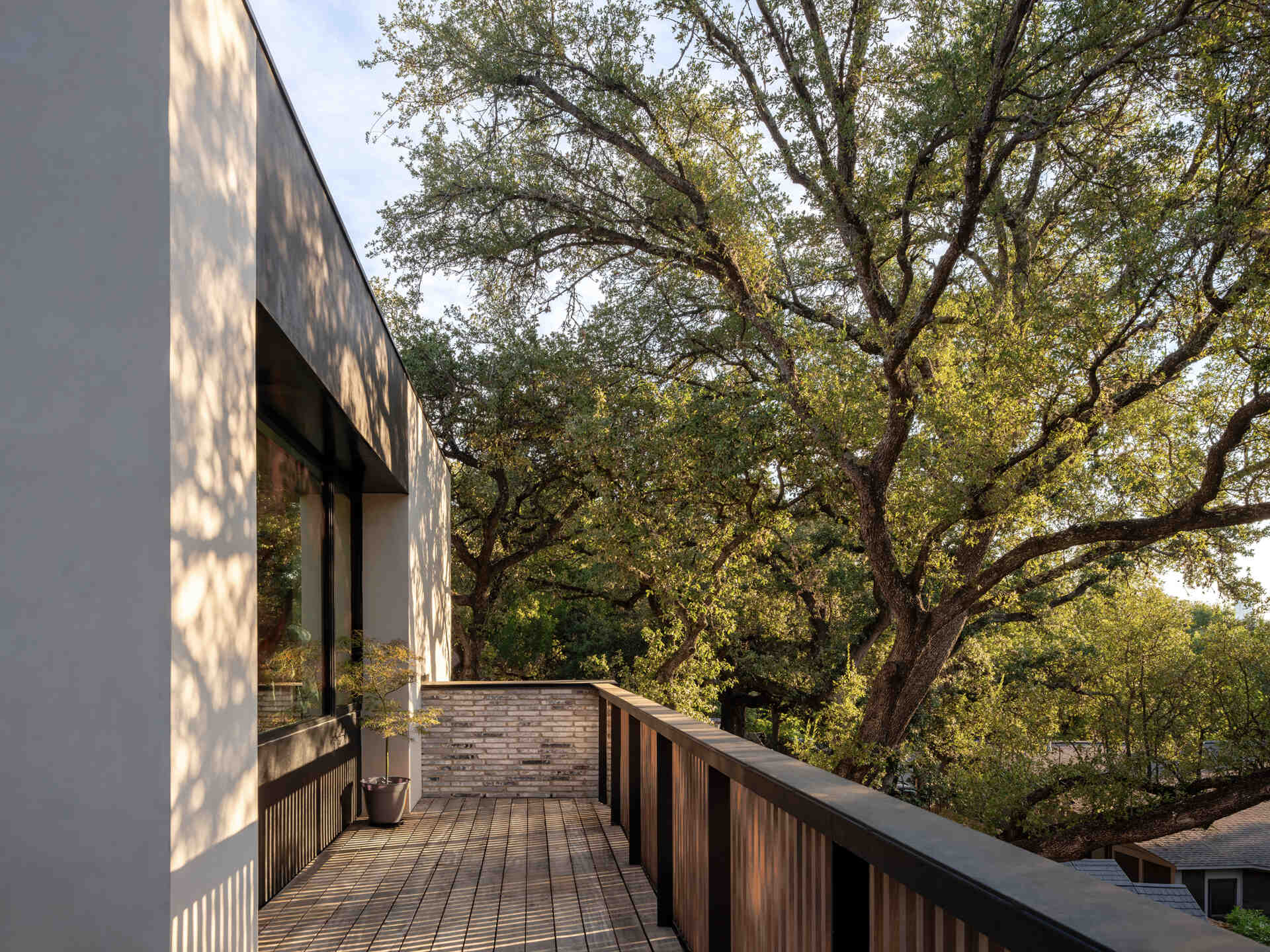 A roof terrace, accessed via the primary bedroom, wrap around the corner of the home.