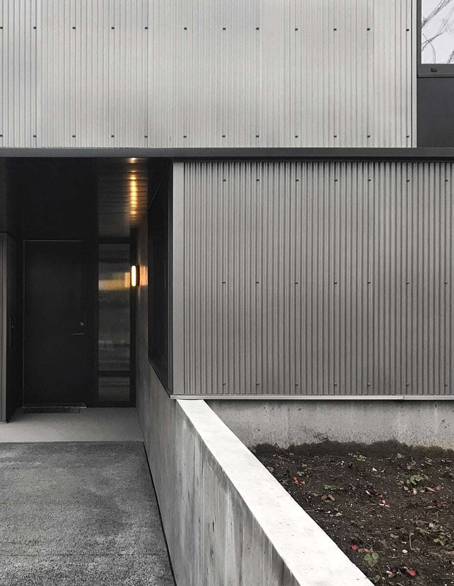 This Seattle home uses corrugated metal siding as its only exterior material, creating a bold yet minimalist look inspired by Japanese Shibui.