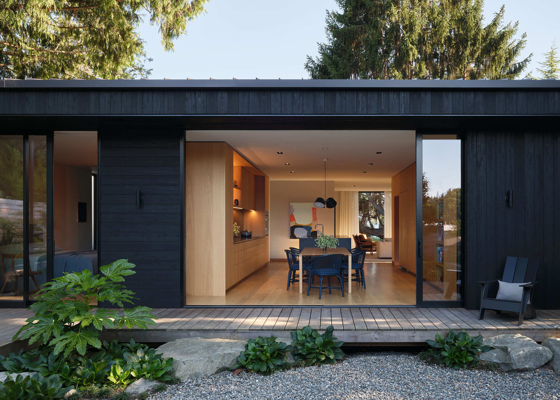 An elevated deck and informal stone steps create a flexible link between the main house and the DADU, allowing the layout to evolve over time.