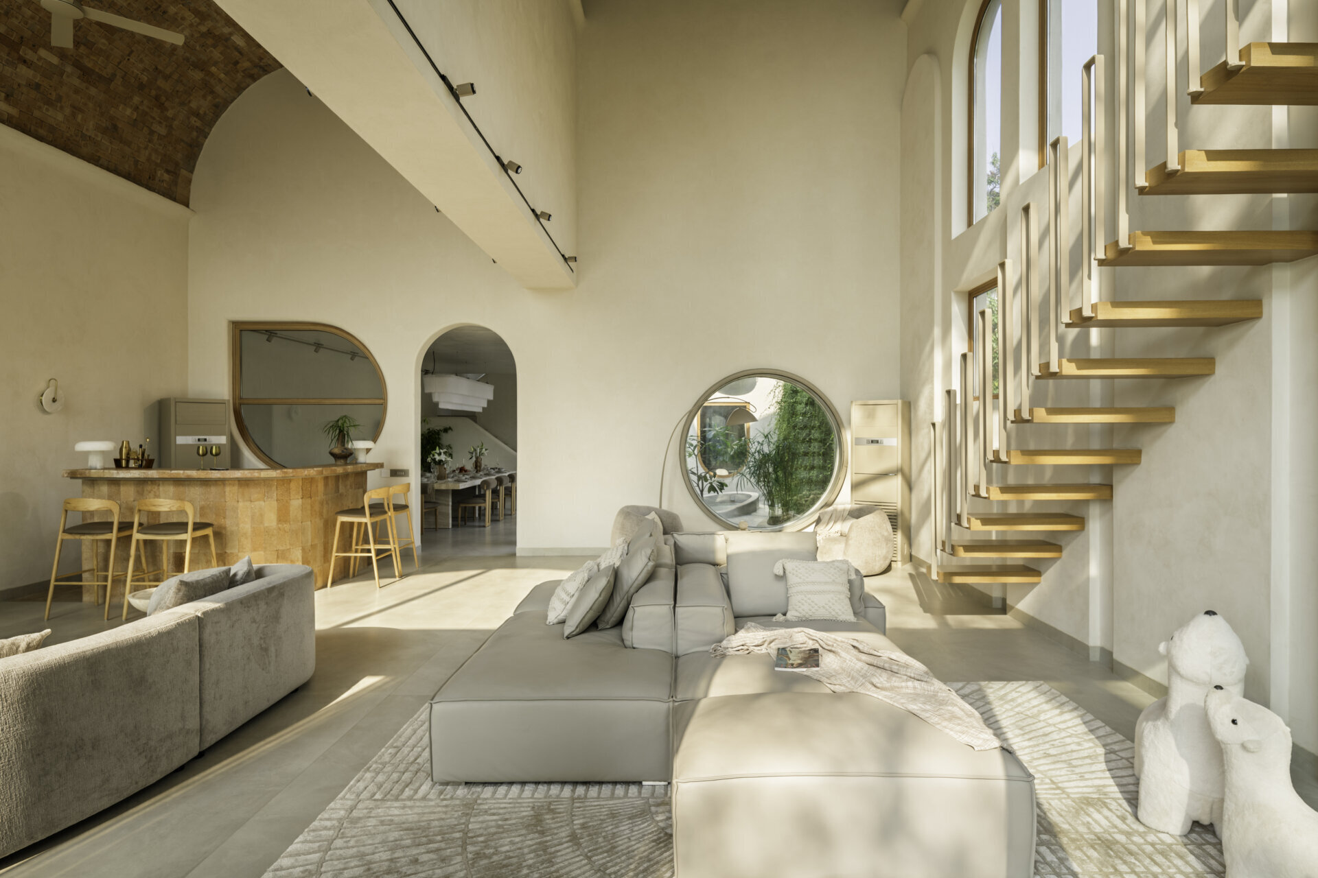 Brick vault ceilings, wooden arches and a stained glass window inspired by the Osho logo shape this serene living space. A tiny balcony offers a private lookout over the surrounding fields and sky.