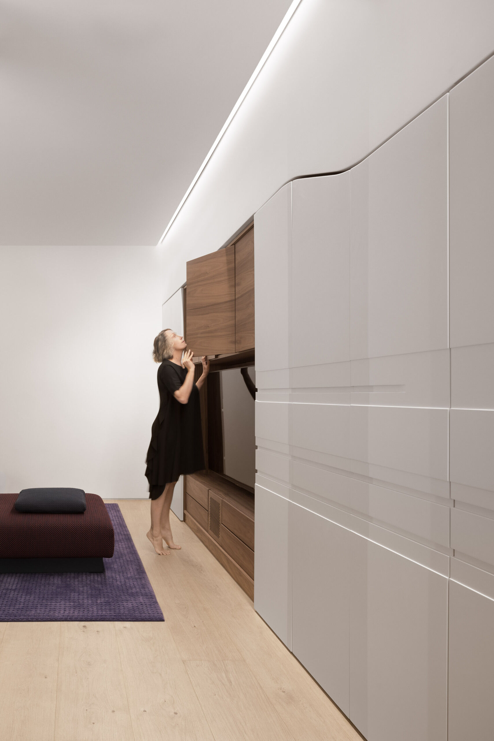 A refined basement includes flush storage, ceiling lighting, and a wood framed media wall.