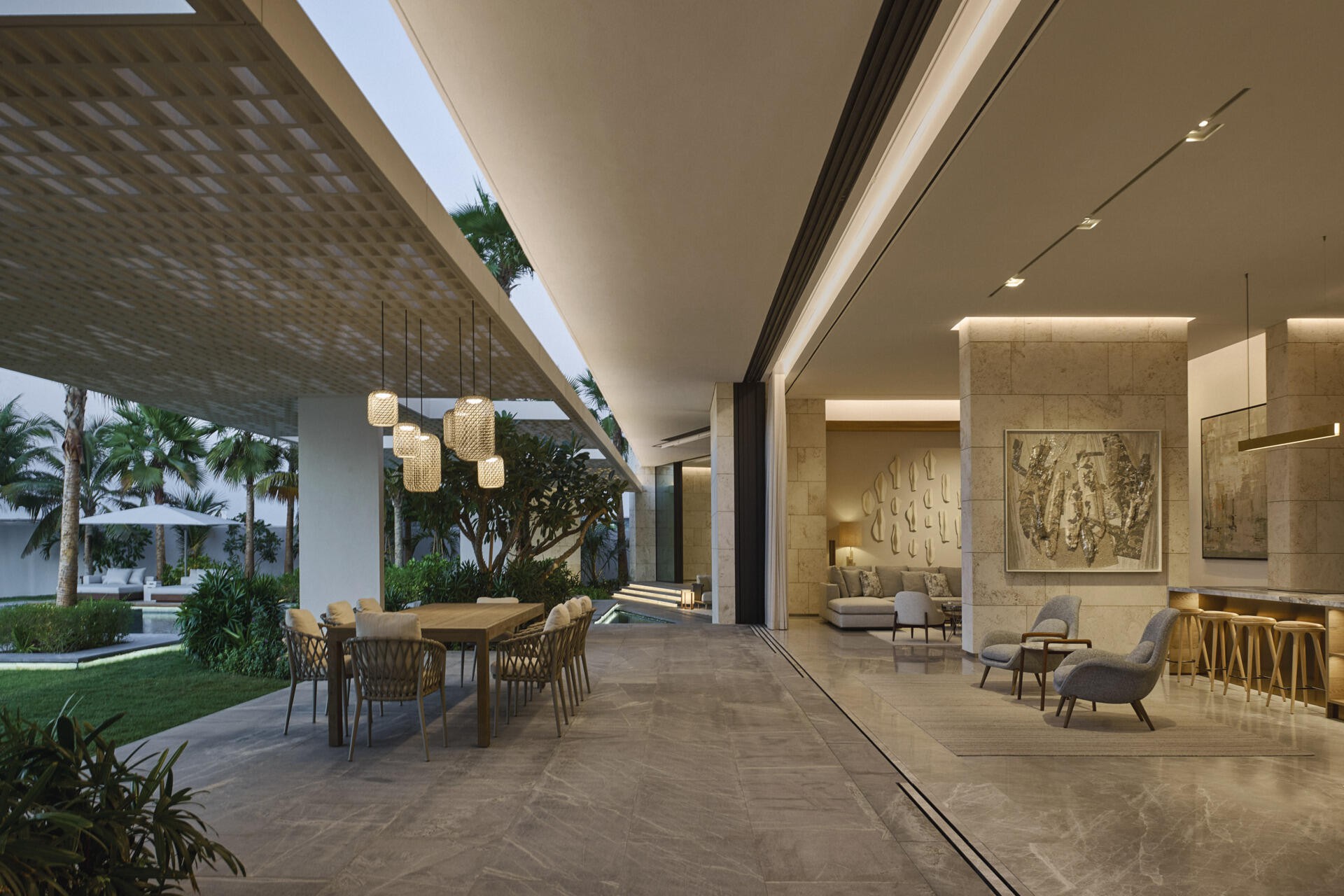 Shaded terraces extend the interior outdoors with generous eaves that reduce glare and heat. Outdoor dining sits within a planted garden setting, connected through wide glazed openings.