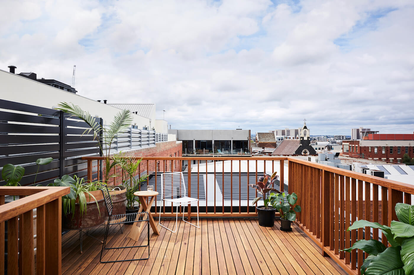 Built-in bench seating in the dining area leads directly to a sunlit rooftop deck.