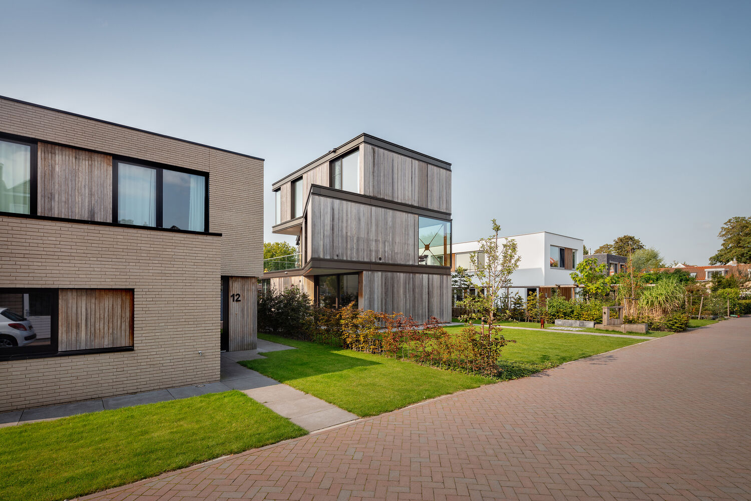 This modern villa in Schiedam features three stacked rectangular floors, with the middle level rotated to create a striking angular form. Wood, metal and glass reference the site’s industrial past while adding a subtle maritime touch.