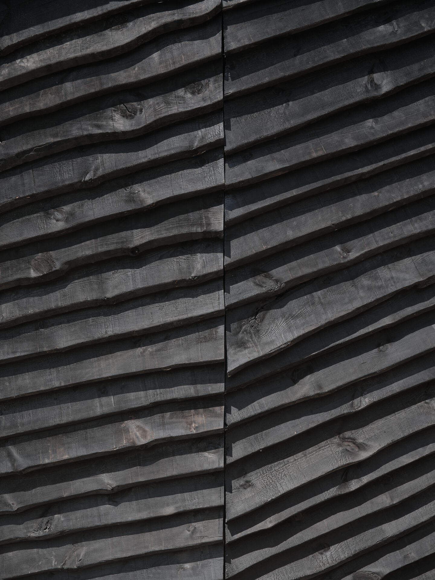 This cabin mimics the surrounding rocks while its charred timber exterior highlights fire management in the mountains.