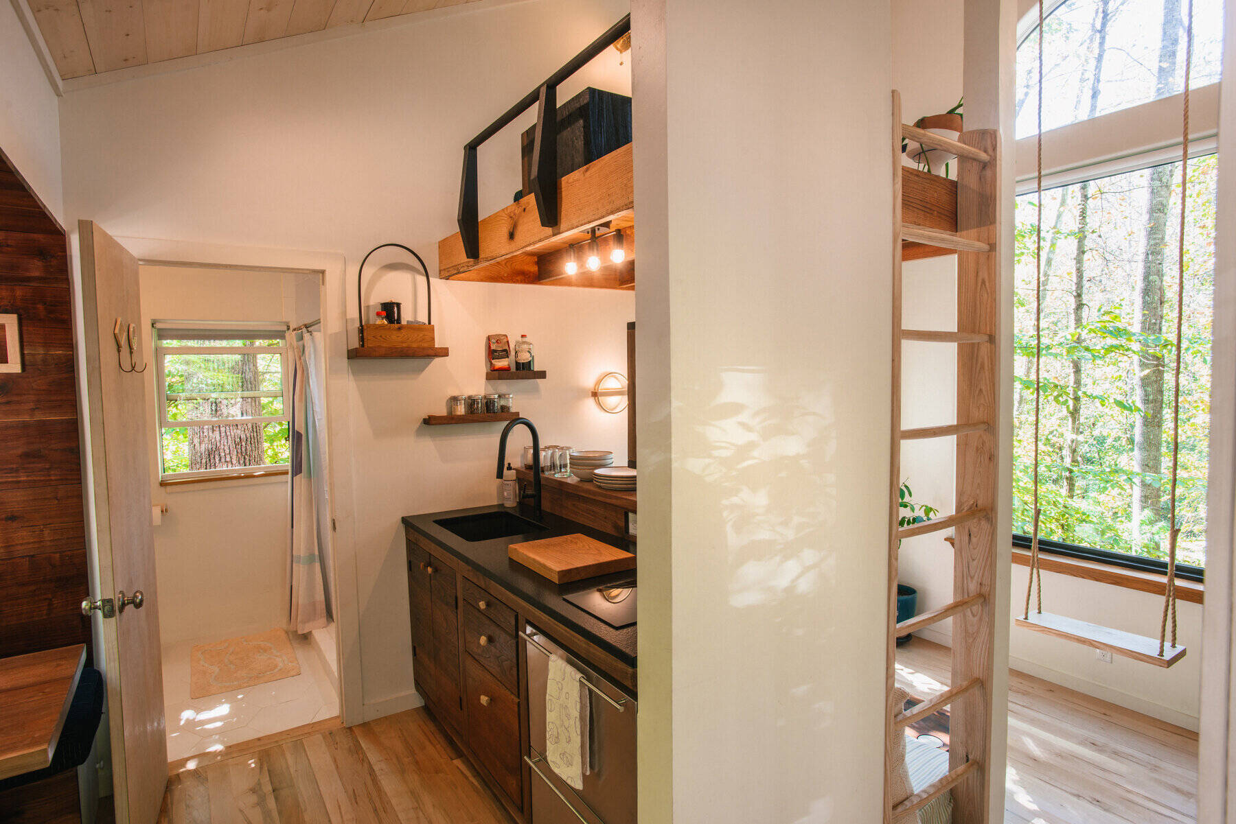 From a breakfast alcove to a tea loft and entertainment loft, this tiny house is packed with clever nooks that make every inch count.