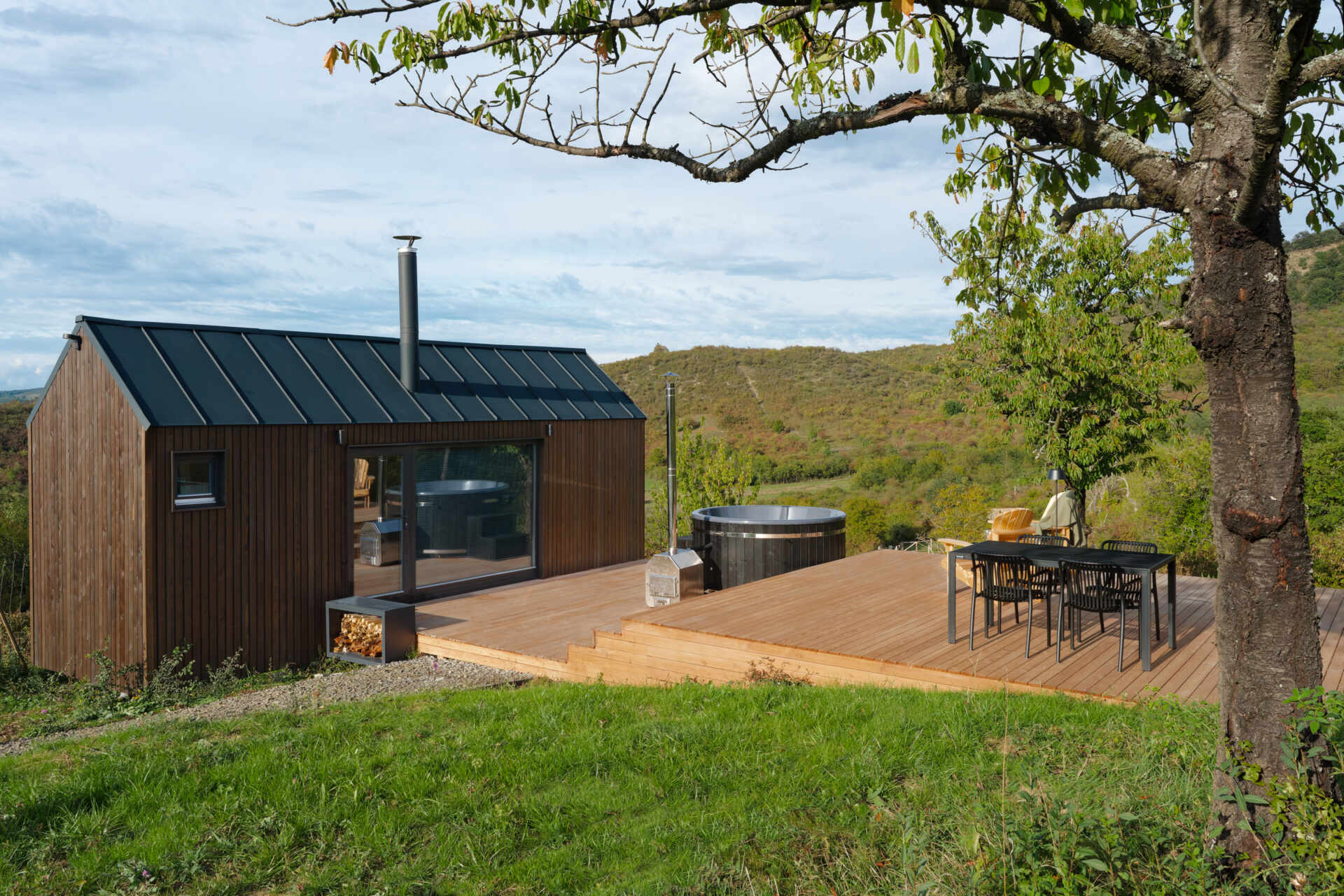 Set on a rolling hillside just outside Budapest, this compact cabin is designed to frame the landscape, not compete with it. With a minimal footprint and partially prefabricated structure, it sits lightly on the terrain while maximizing every view.