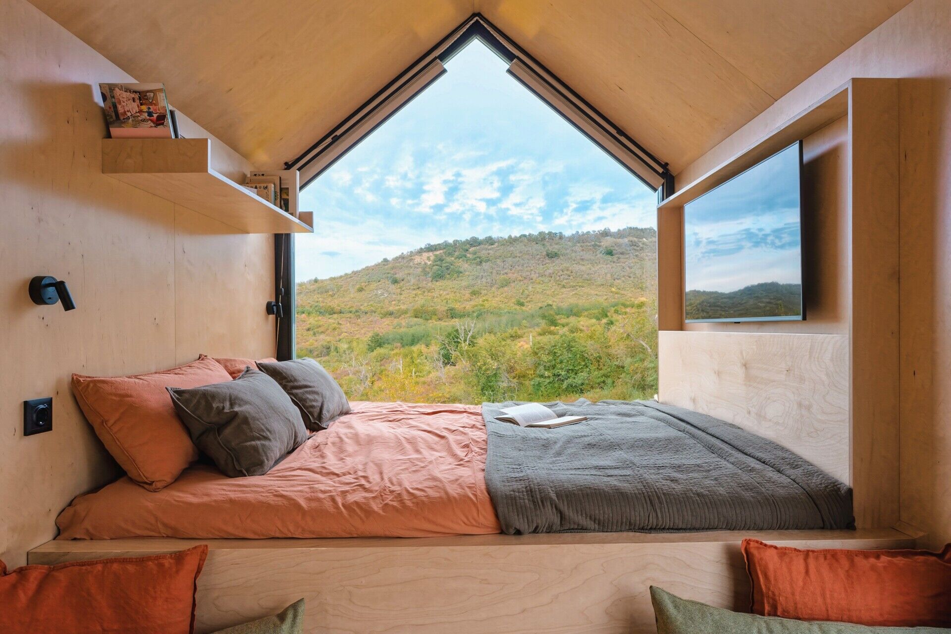 Set on a rolling hillside just outside Budapest, this compact cabin is designed to frame the landscape, not compete with it. With a minimal footprint and partially prefabricated structure, it sits lightly on the terrain while maximizing every view.