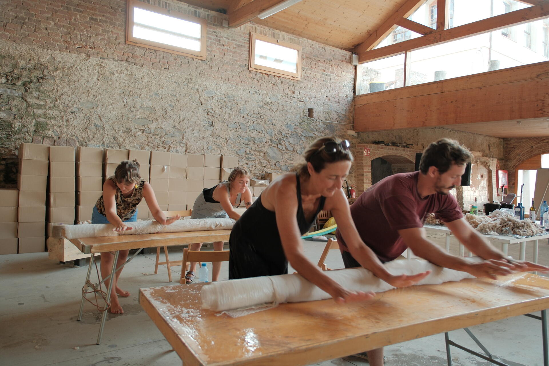 MAKING OF - Inside a small cabin, custom timber furniture, a carved stone basin, and wool textiles connect local craftsmanship with design.