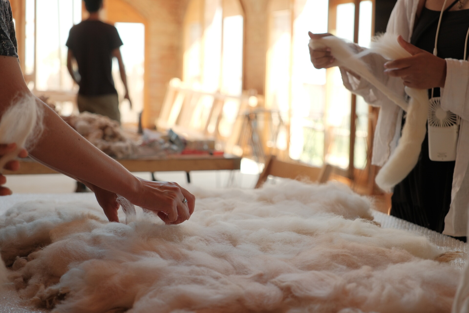 MAKING OF - Inside a small cabin, custom timber furniture, a carved stone basin, and wool textiles connect local craftsmanship with design.
