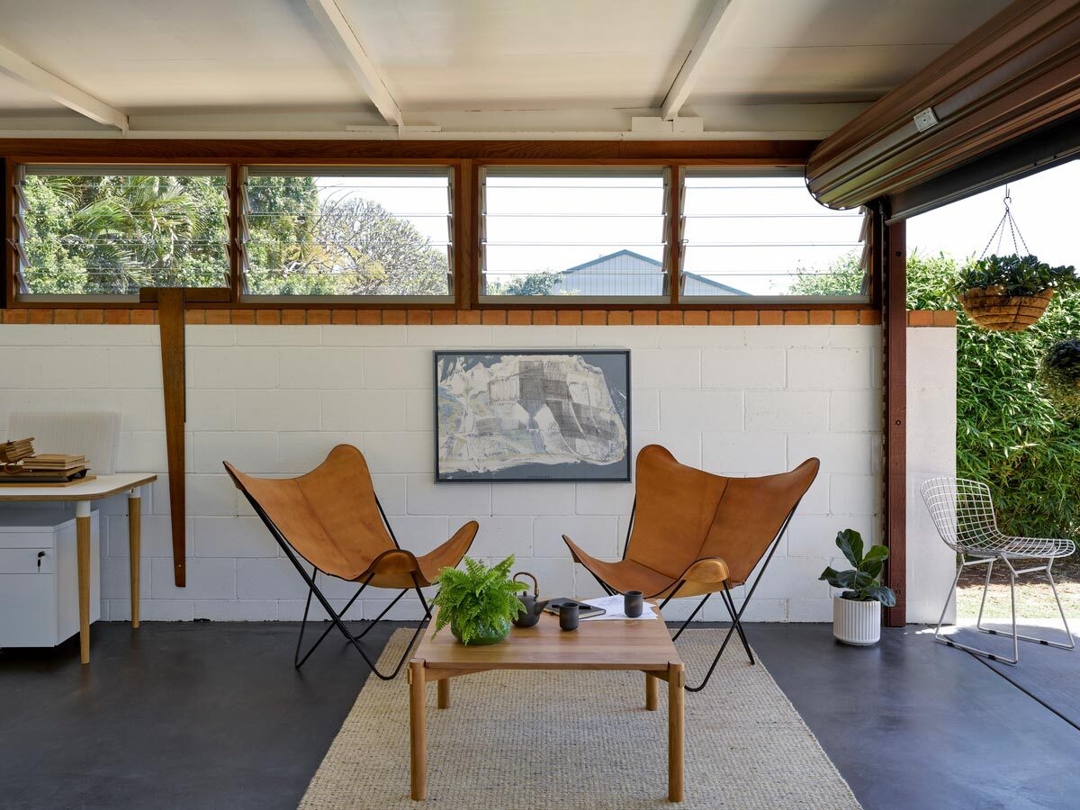 White walls and a repurposed timber bench create a clean workspace with subtle character.