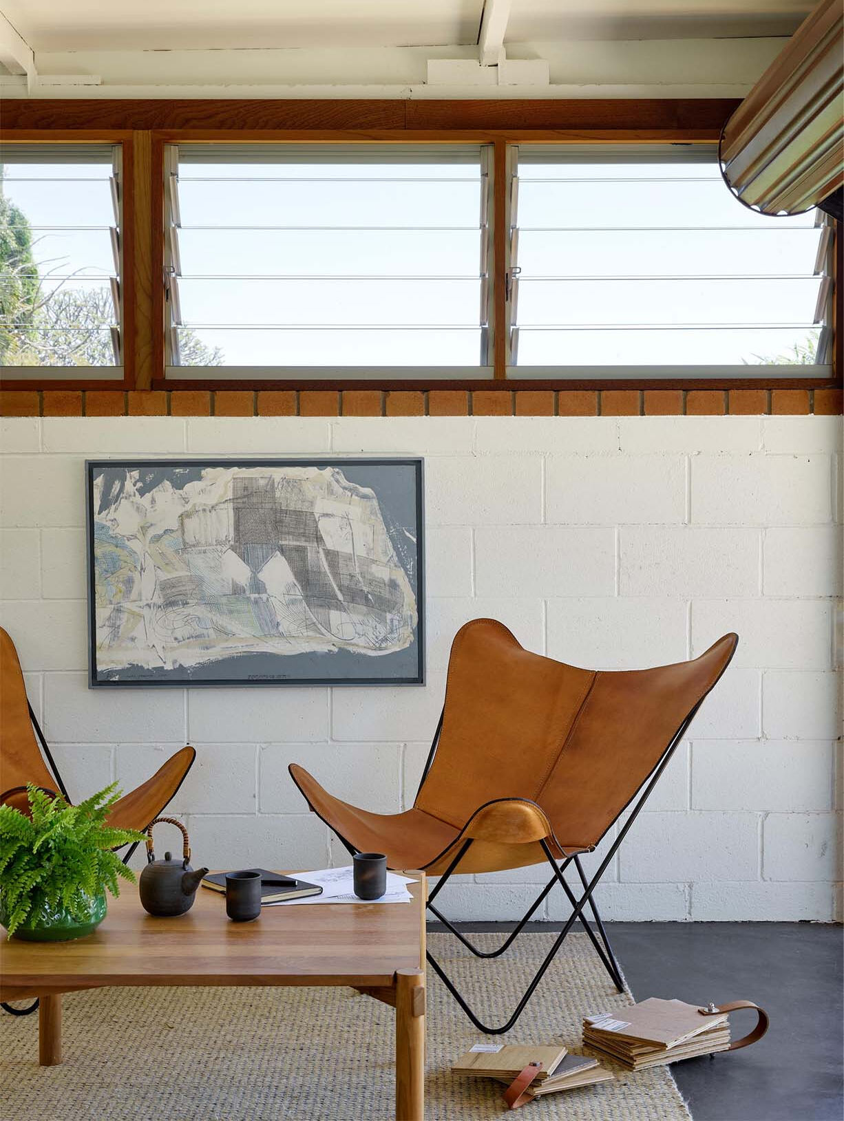 White walls and a repurposed timber bench create a clean workspace with subtle character.