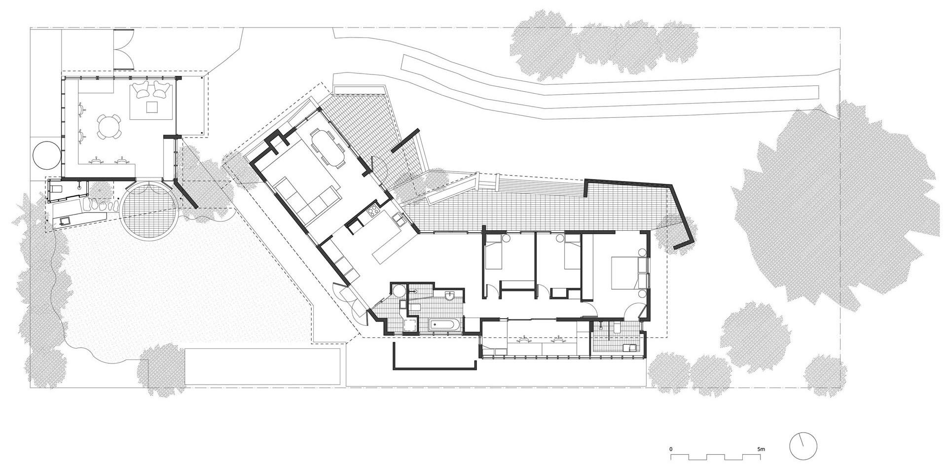 The floor plan reveals how a small garage footprint can support work, kitchen, and bathroom in one layout.