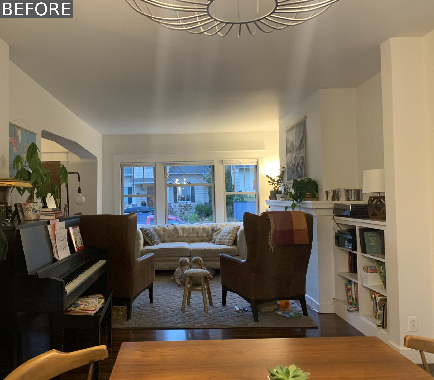 BEFORE RENOVATION - Soft white walls and warm wood tones bring new light and openness to the original interiors of this renovated Craftsman home.