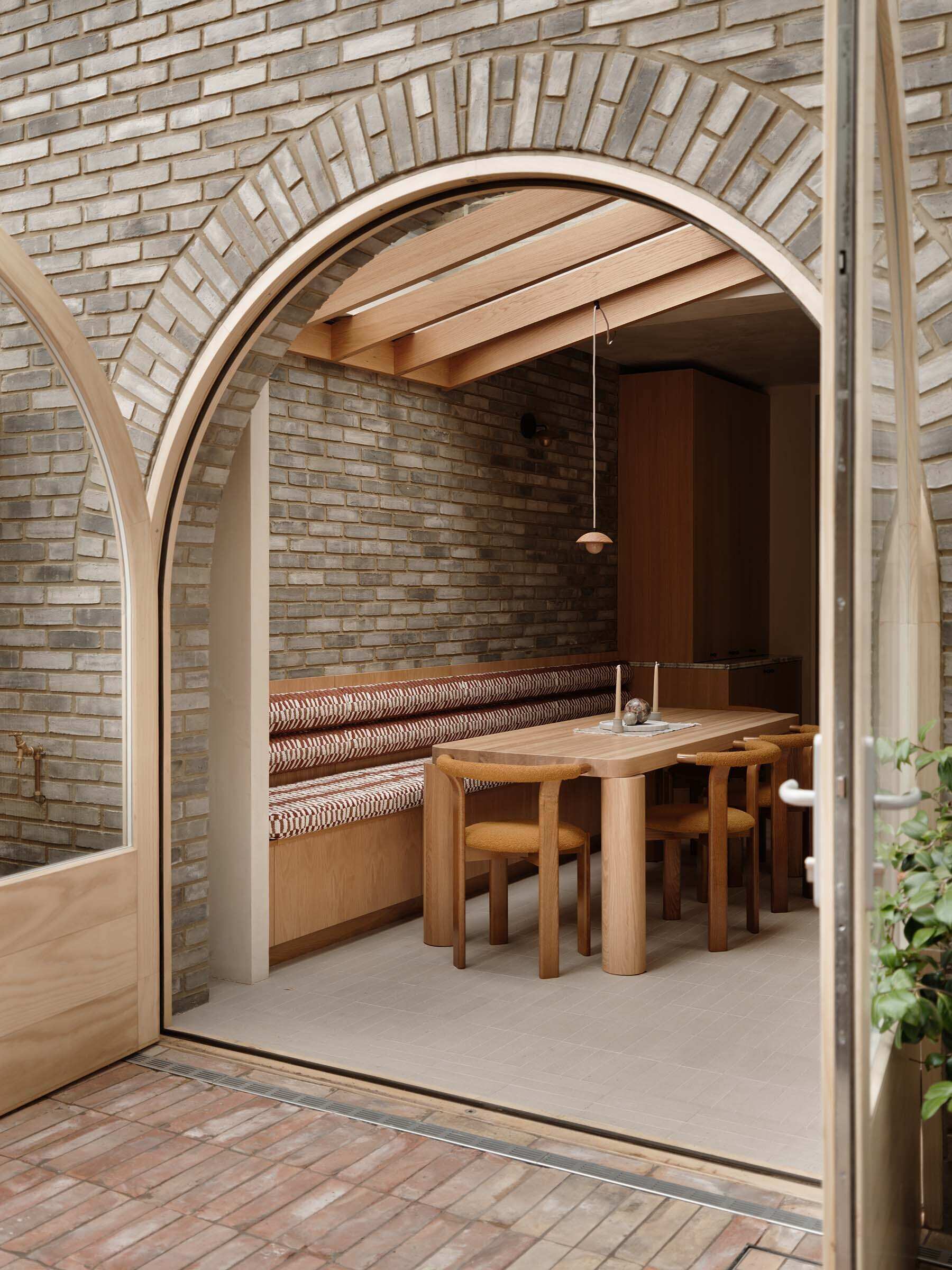 On this brick extension, arched doors and soft curves introduce a subtle architectural detail that references Georgian style while improving flow between spaces.