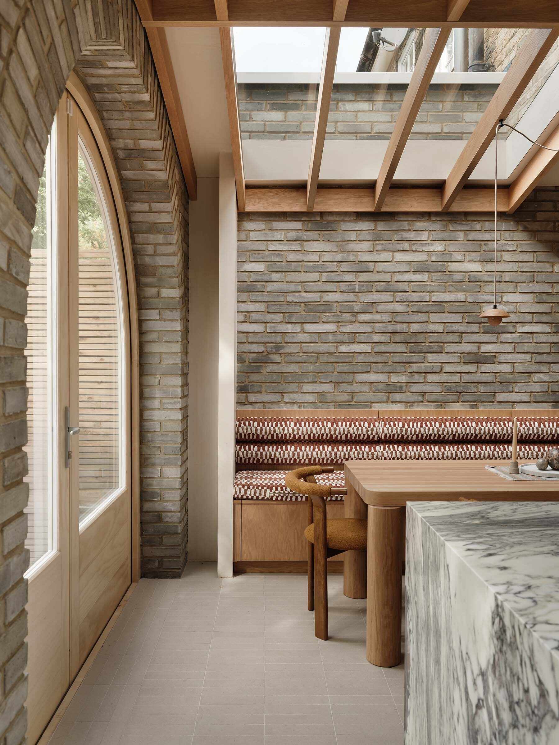 On this brick extension, arched doors and soft curves introduce a subtle architectural detail that references Georgian style while improving flow between spaces.