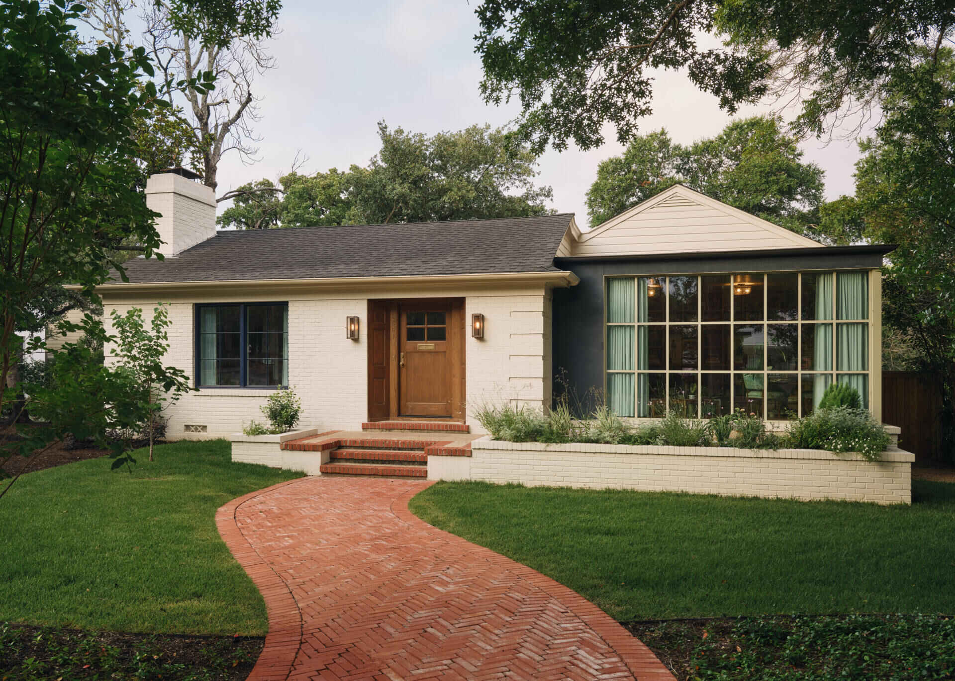 The Windsor Residence features two modern box additions set into the original brick home, creating a subtle contrast that blends historic character with contemporary design.