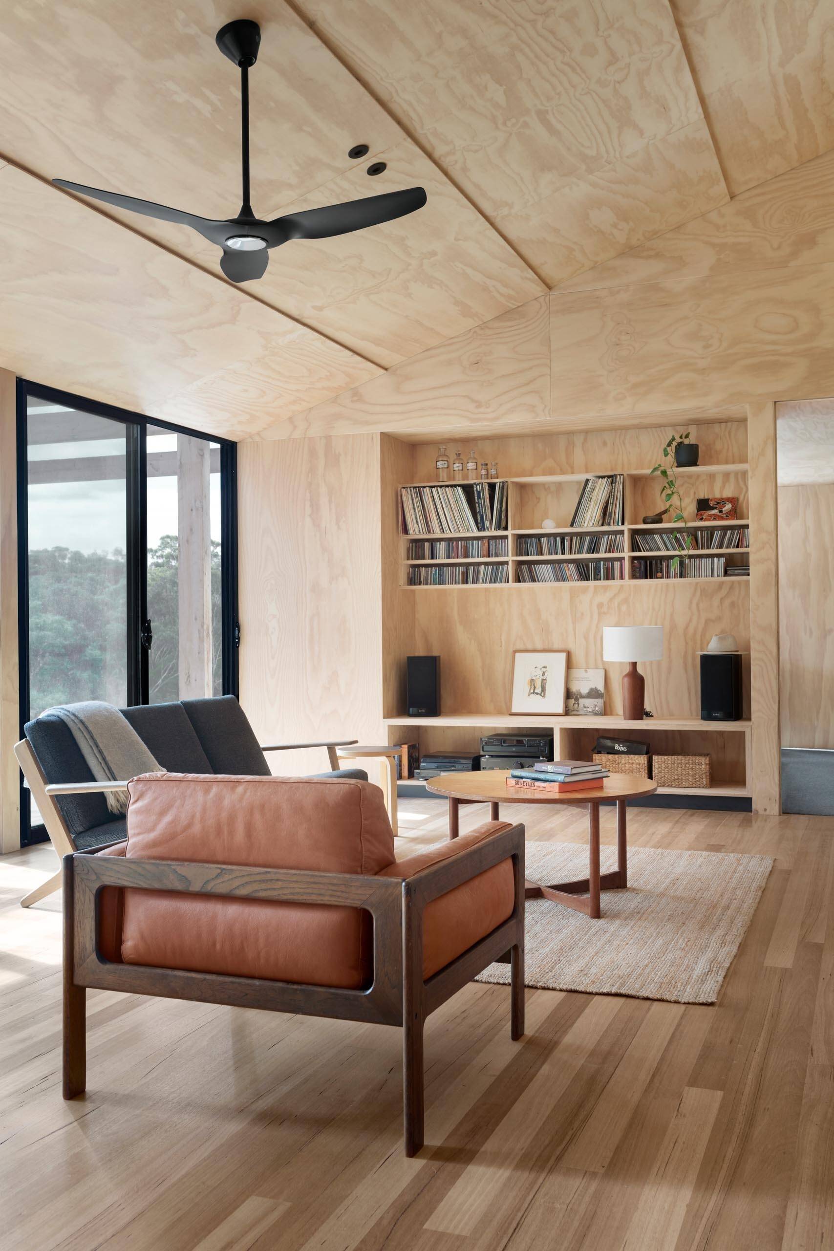Plywood-lined interiors bring warmth to this modern home, with overlapping ceiling panels designed to reduce waste and add subtle texture.